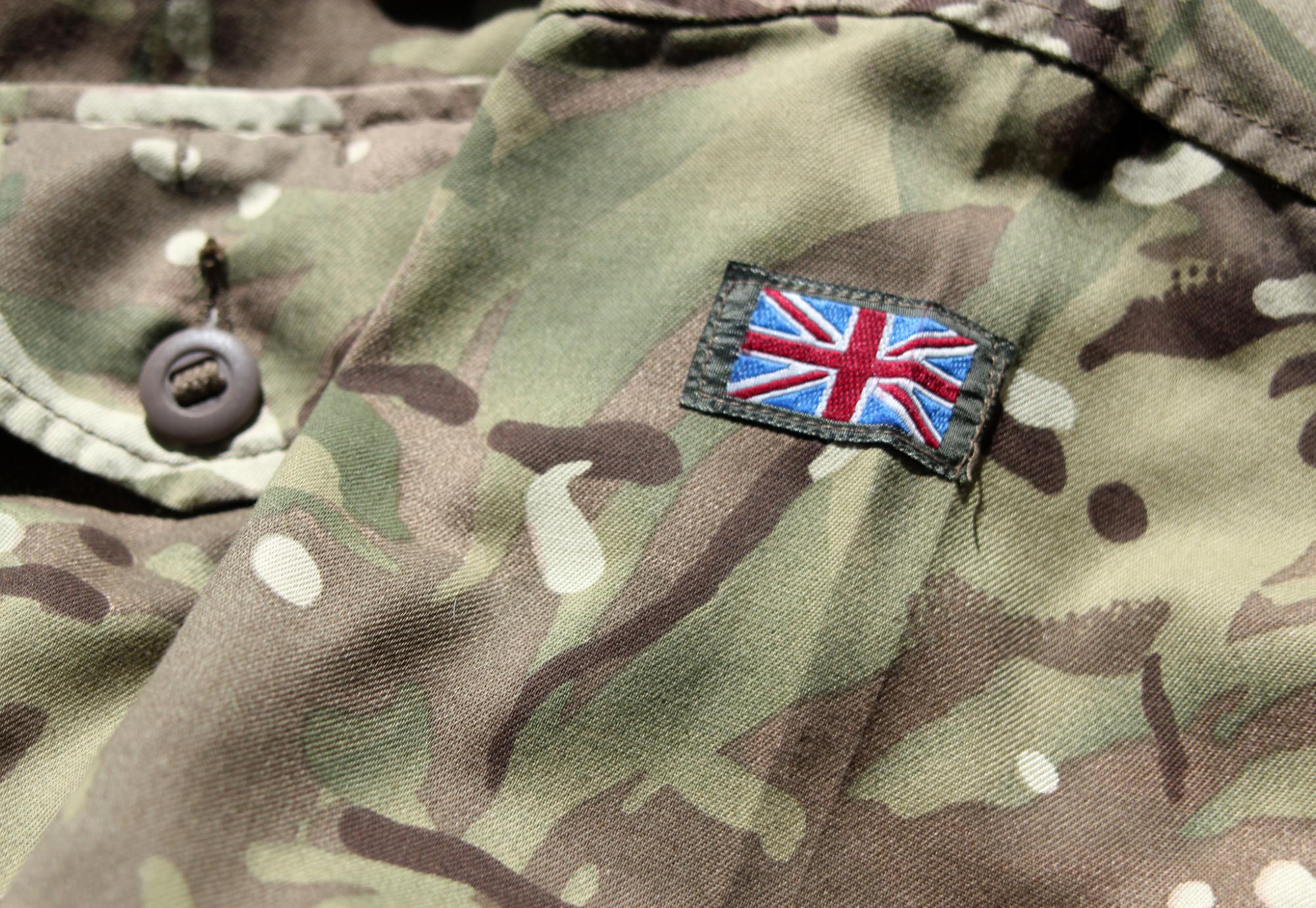 Close up photograph of British military uniform with stitched Union Jack flag