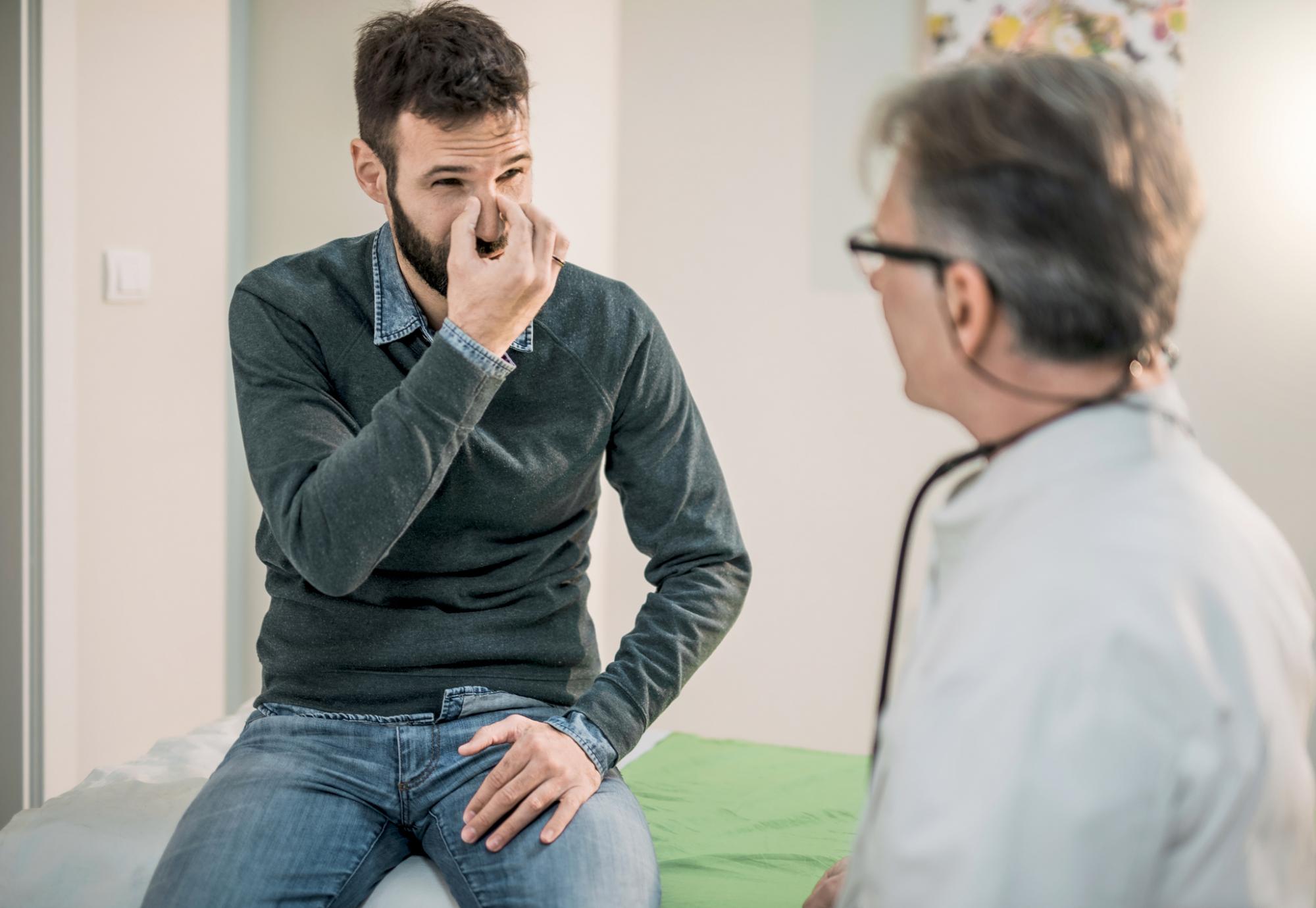 Male patient describing breathing troubles with a doctor