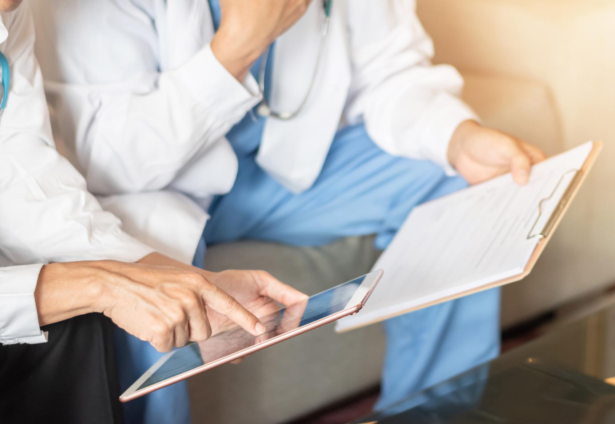 Two medical professionals looking at an iPad 