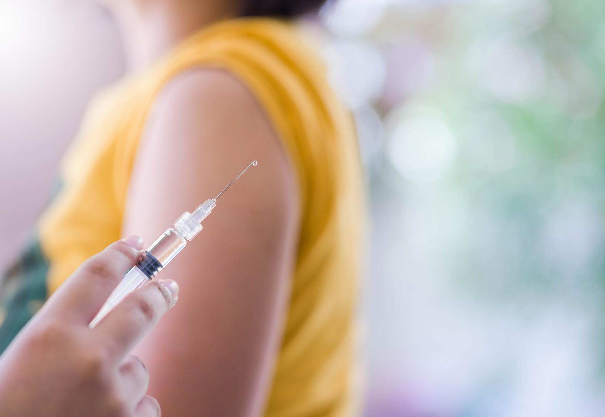 Close up of a needle before giving a vaccine jab