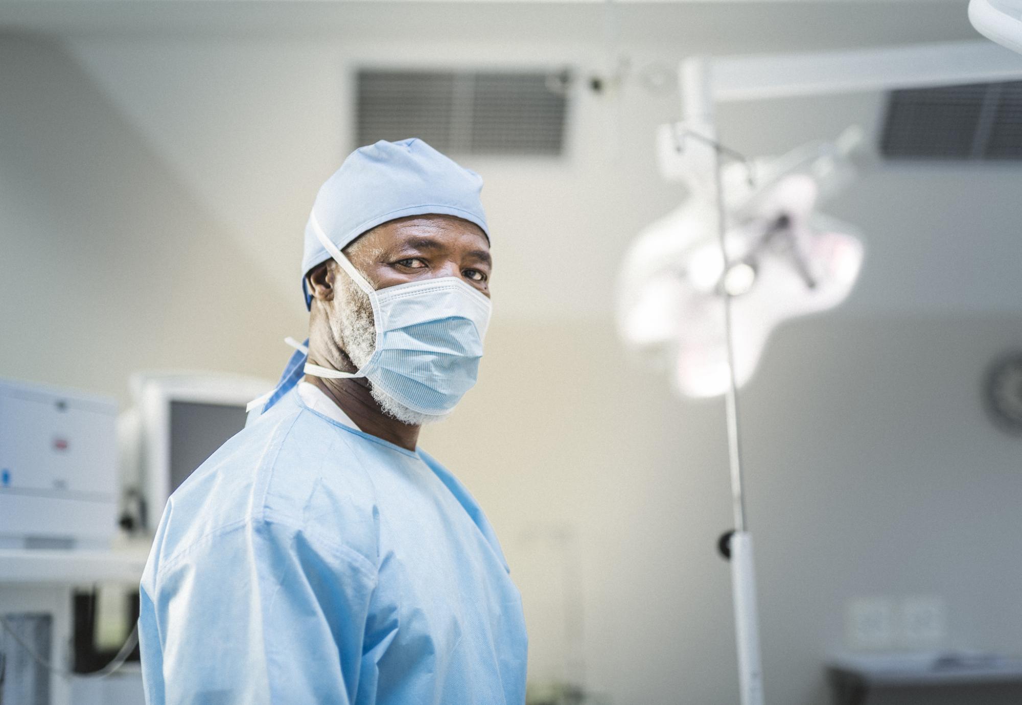 BAME surgeon standing in an operating theatre