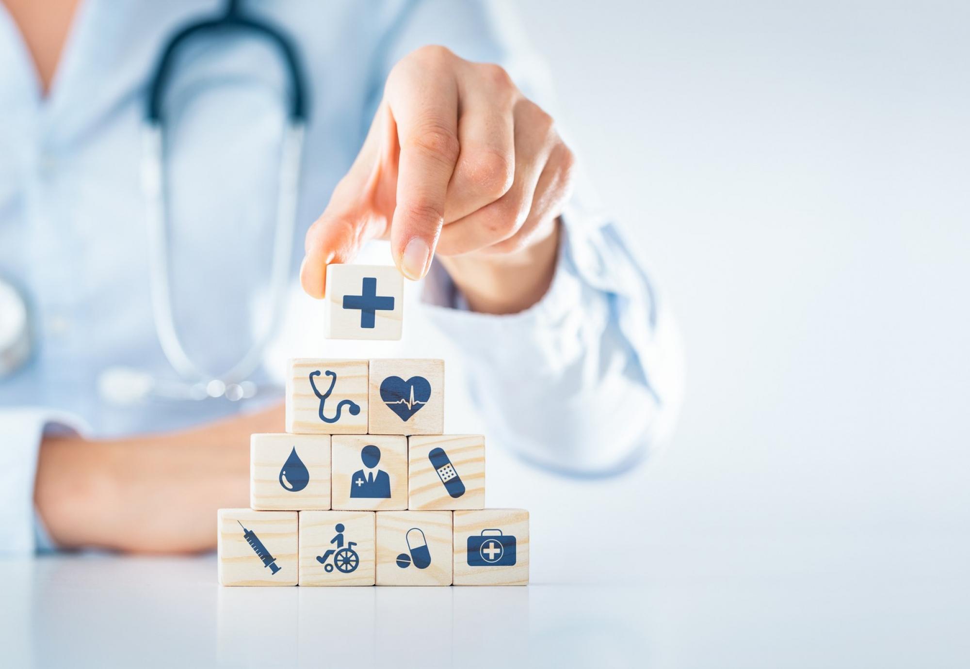 Illustration of the building blocks of health; health professional stacking objects