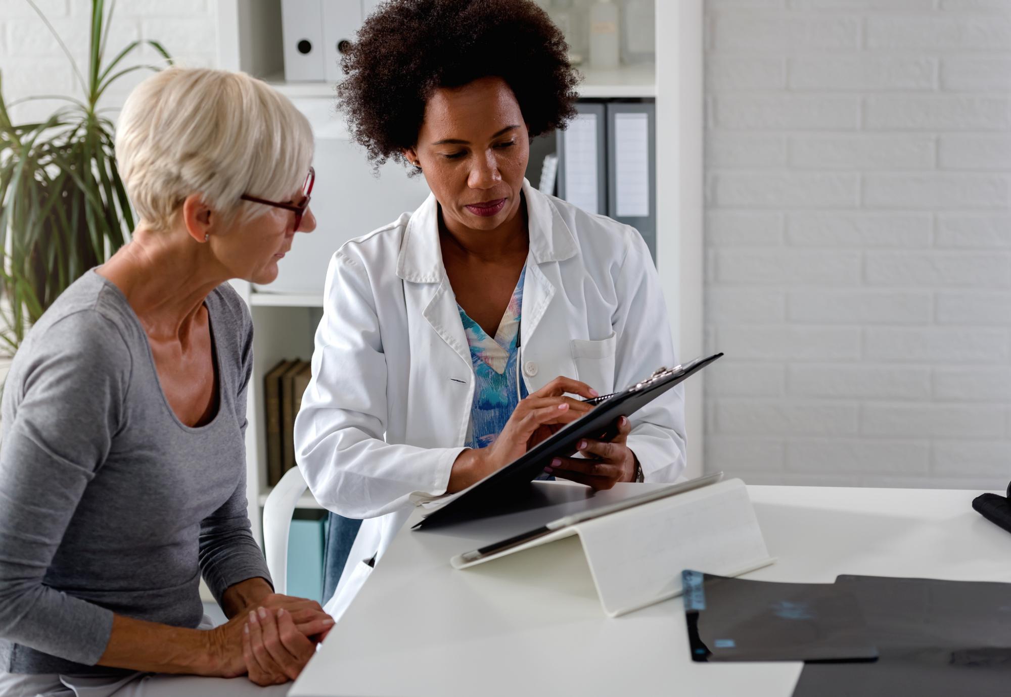 Female doctor at a desk discussing with a patient