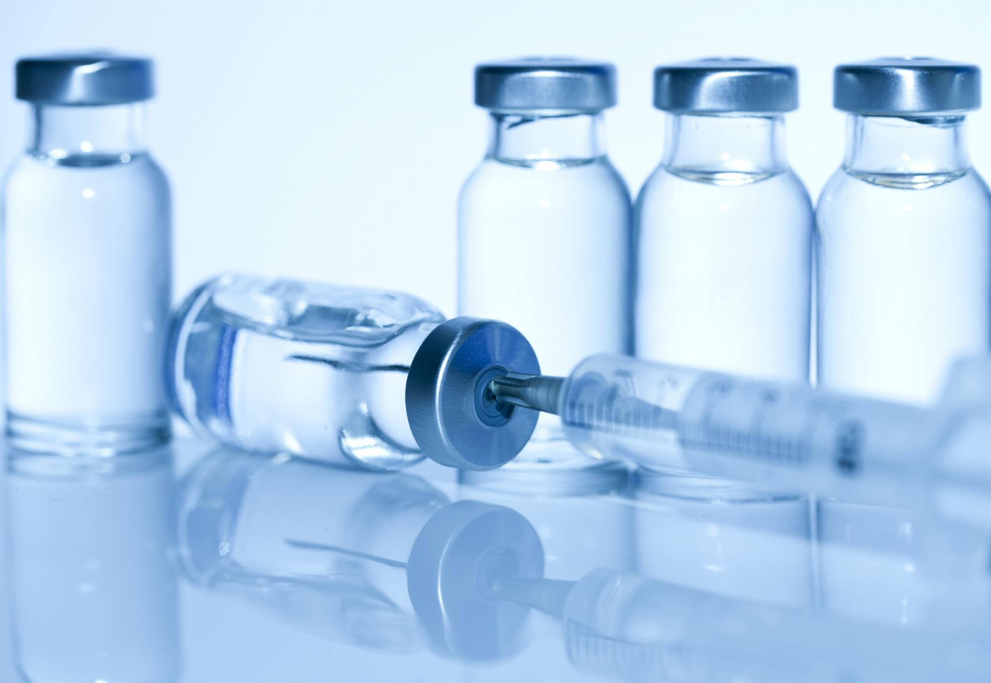 Vaccine bottle with syringe in the top