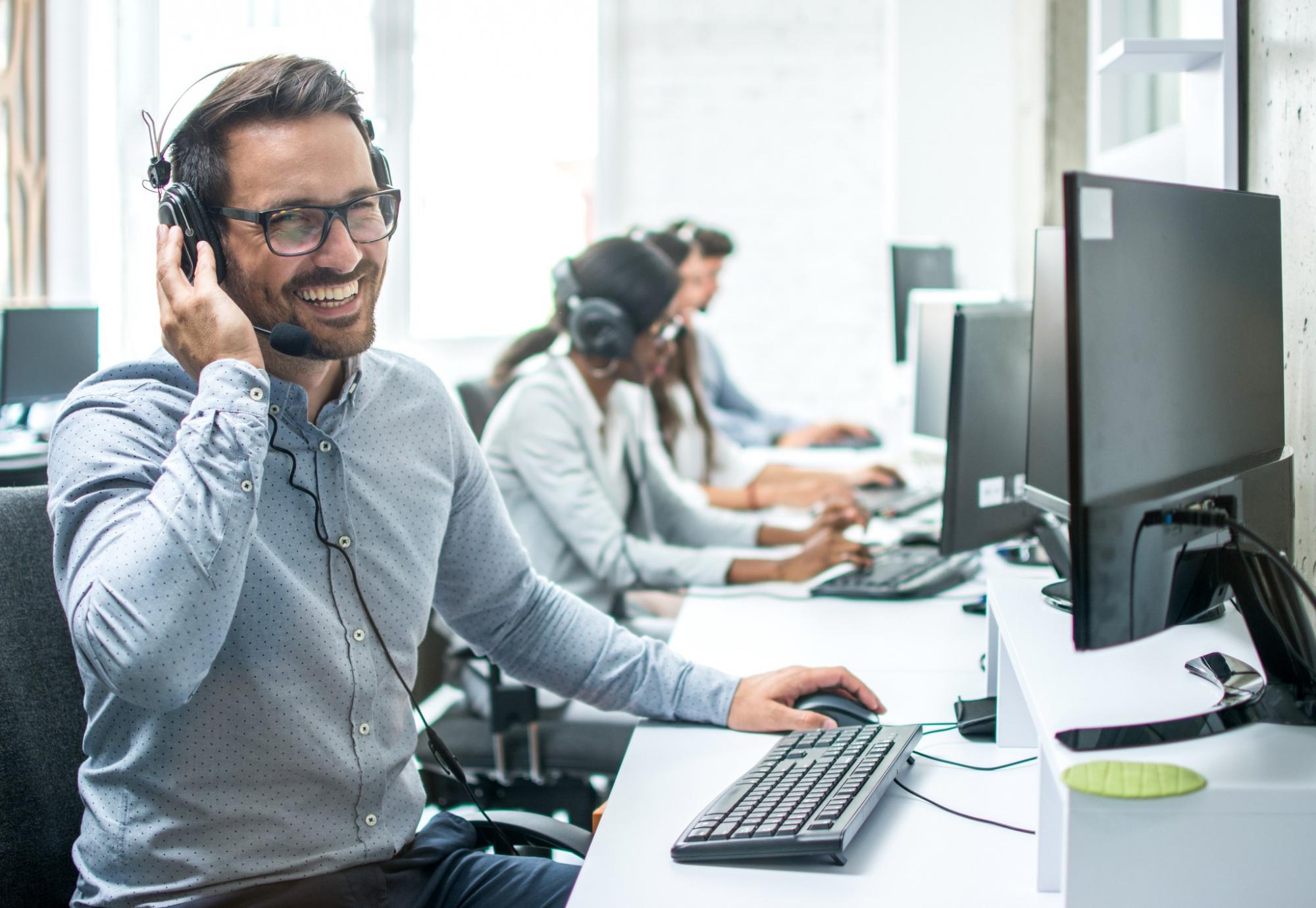 Smiling call centre phone operator, representative of NHS Test and Trace caller