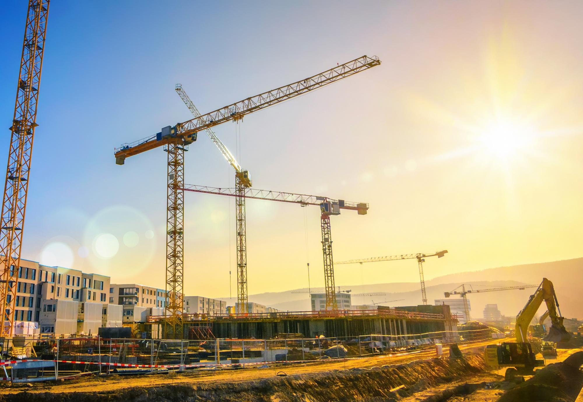 Cranes in operation above a construction site