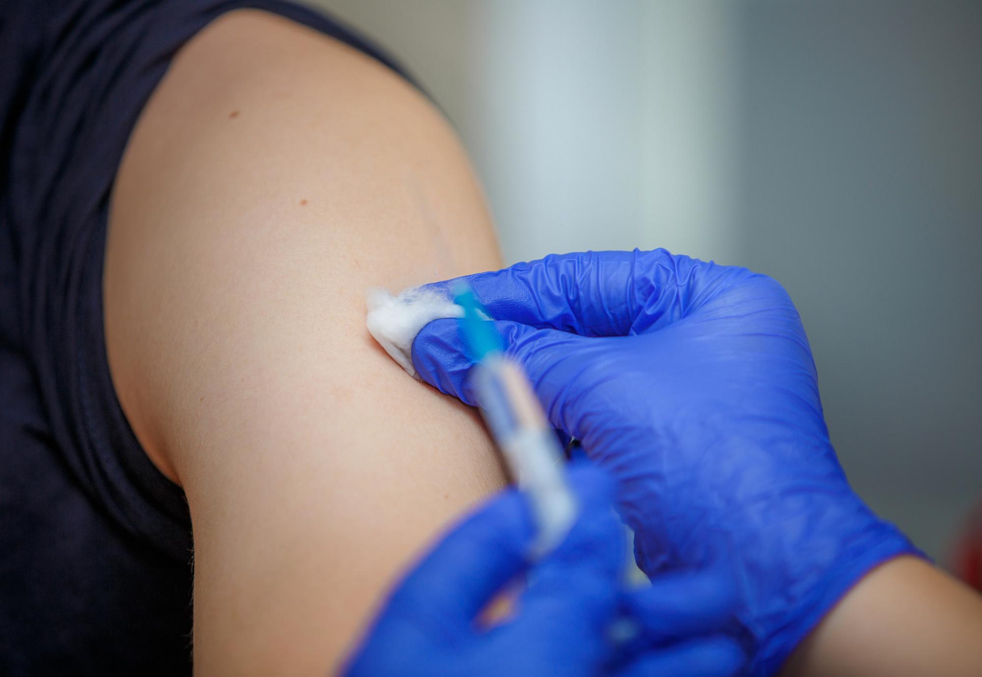 Vaccine dose being administered in a patient's arm