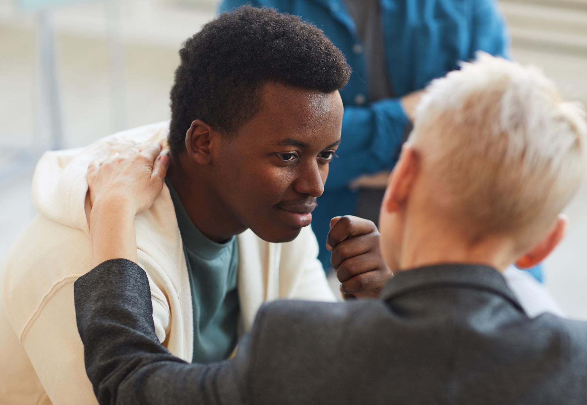 Young man talking with a health professional