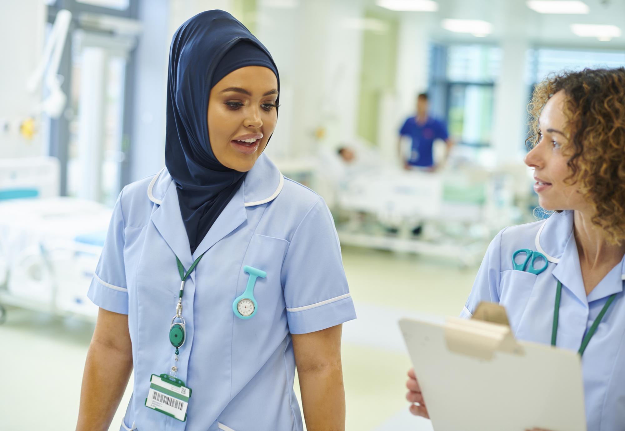 Nurses talking as they complete a ward round