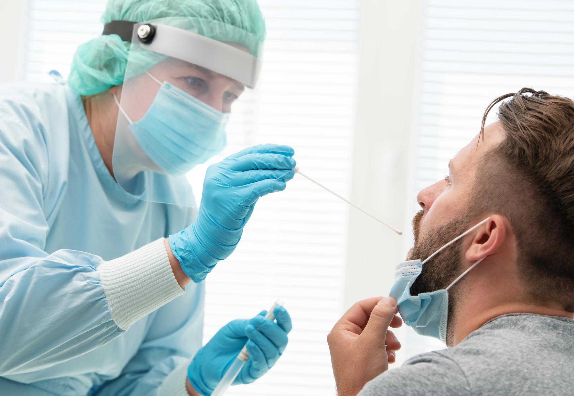 Health professional carrying out a nasal swab on a patient