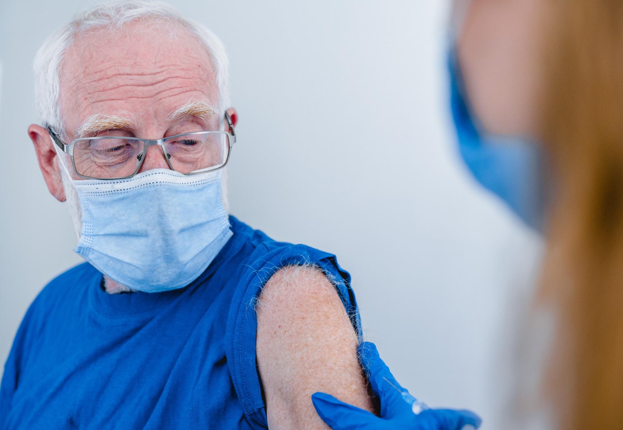 Elderly man preparing to receive his vaccine jab