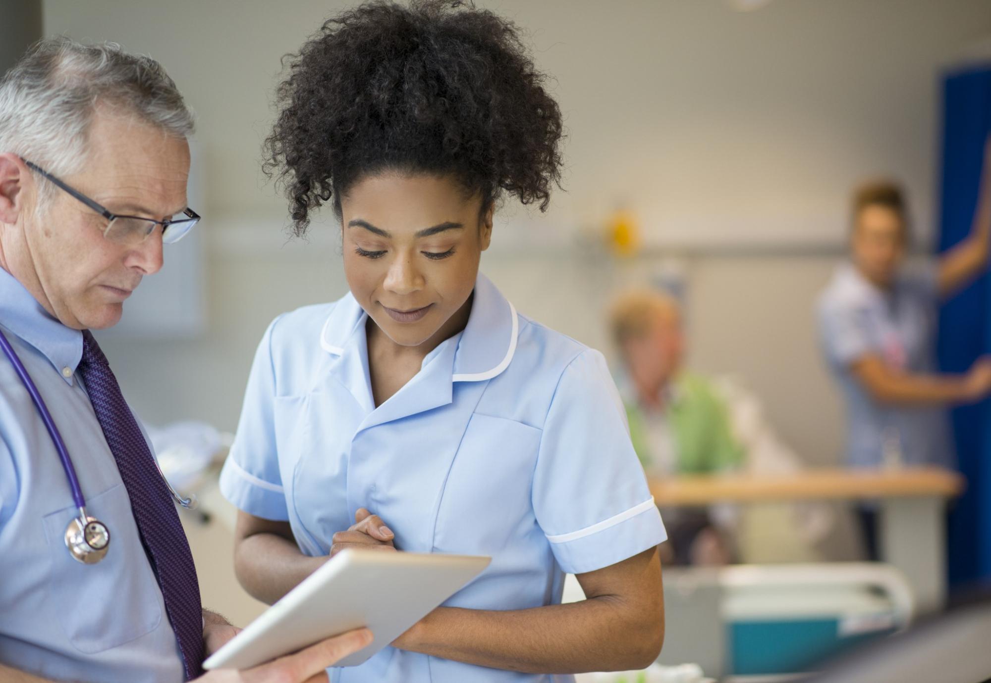 Nurse and a health administrator discussing information