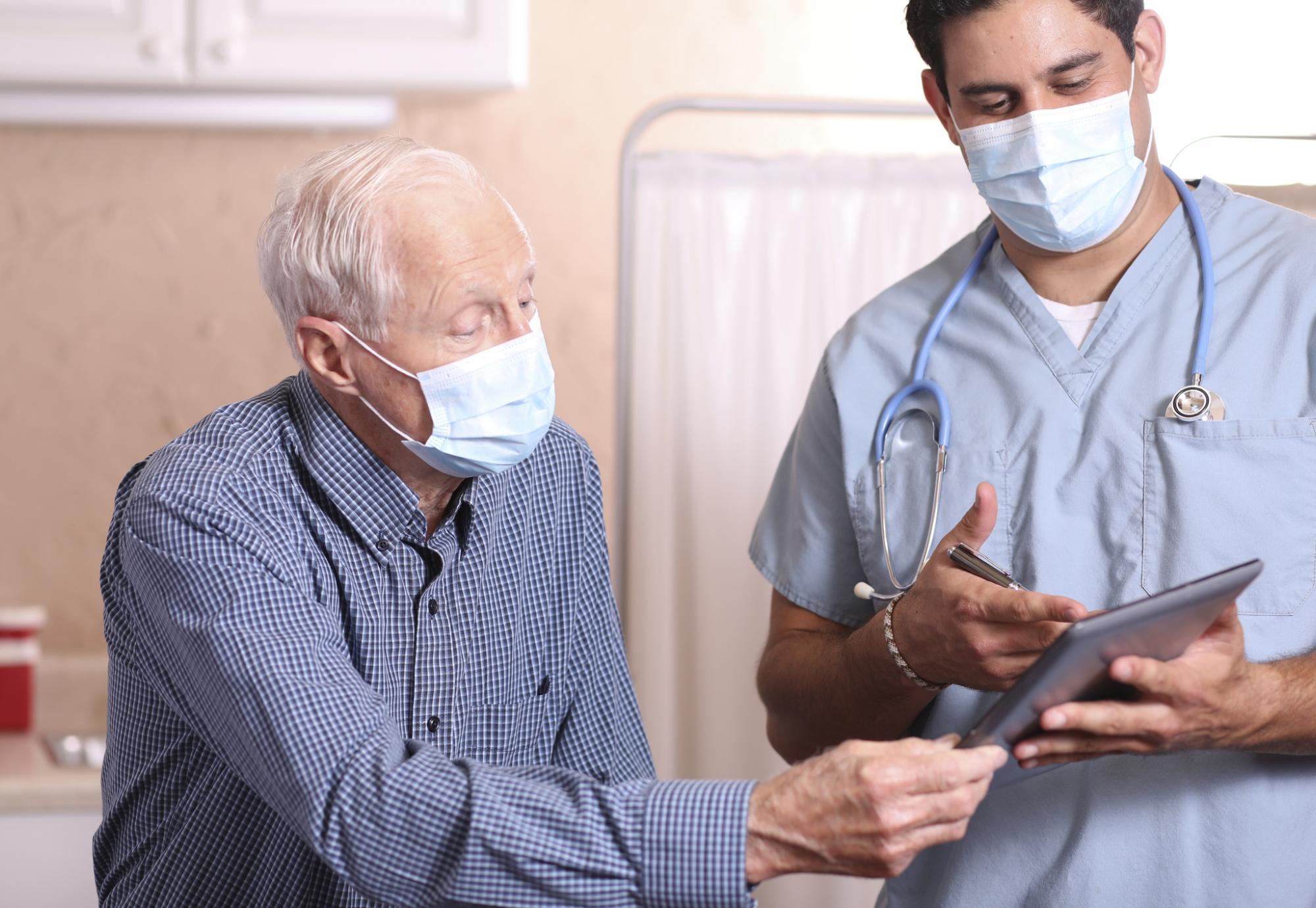 Elderly patient talking with a hospital clinician