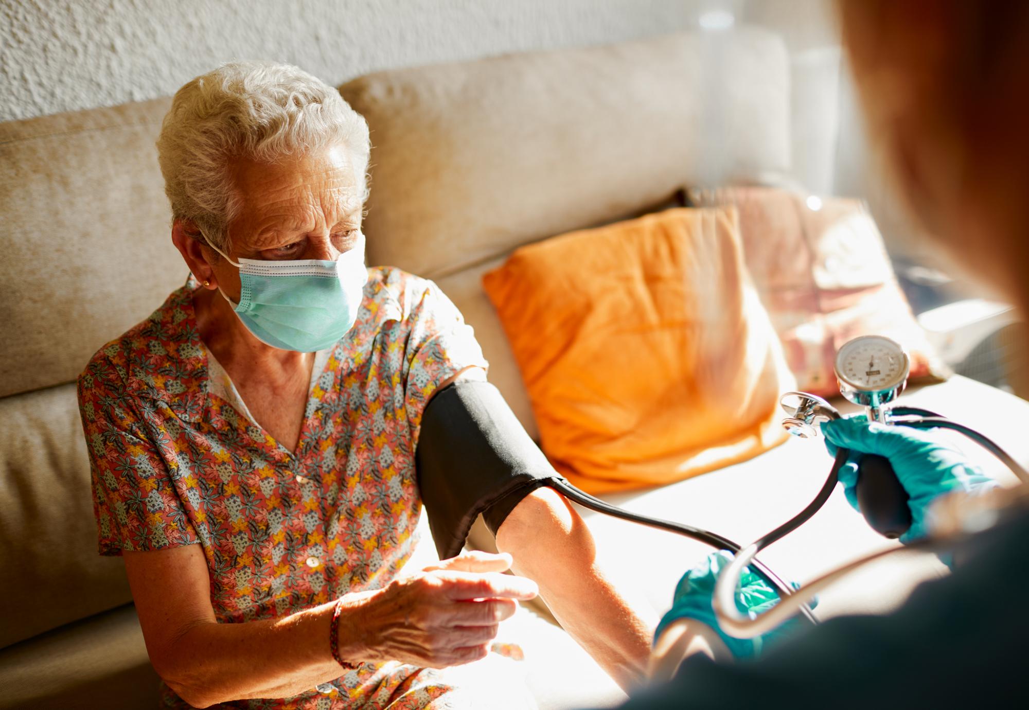 Care home patient having blood pressure taken