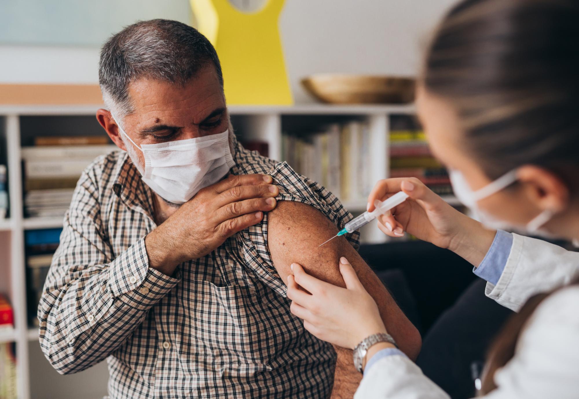 Doctor administering a vaccine jab