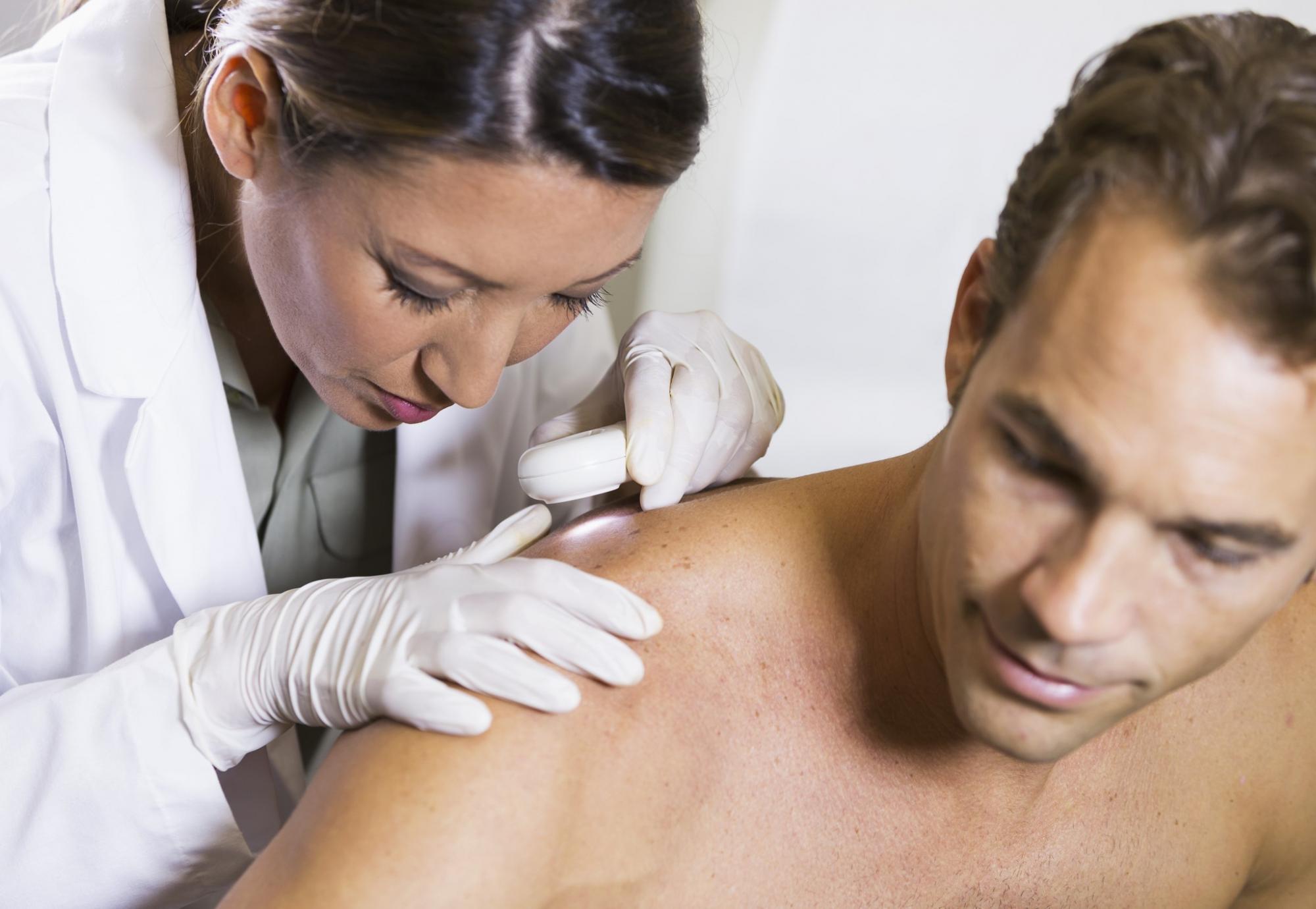 Dermatologist inspecting a patient's skin