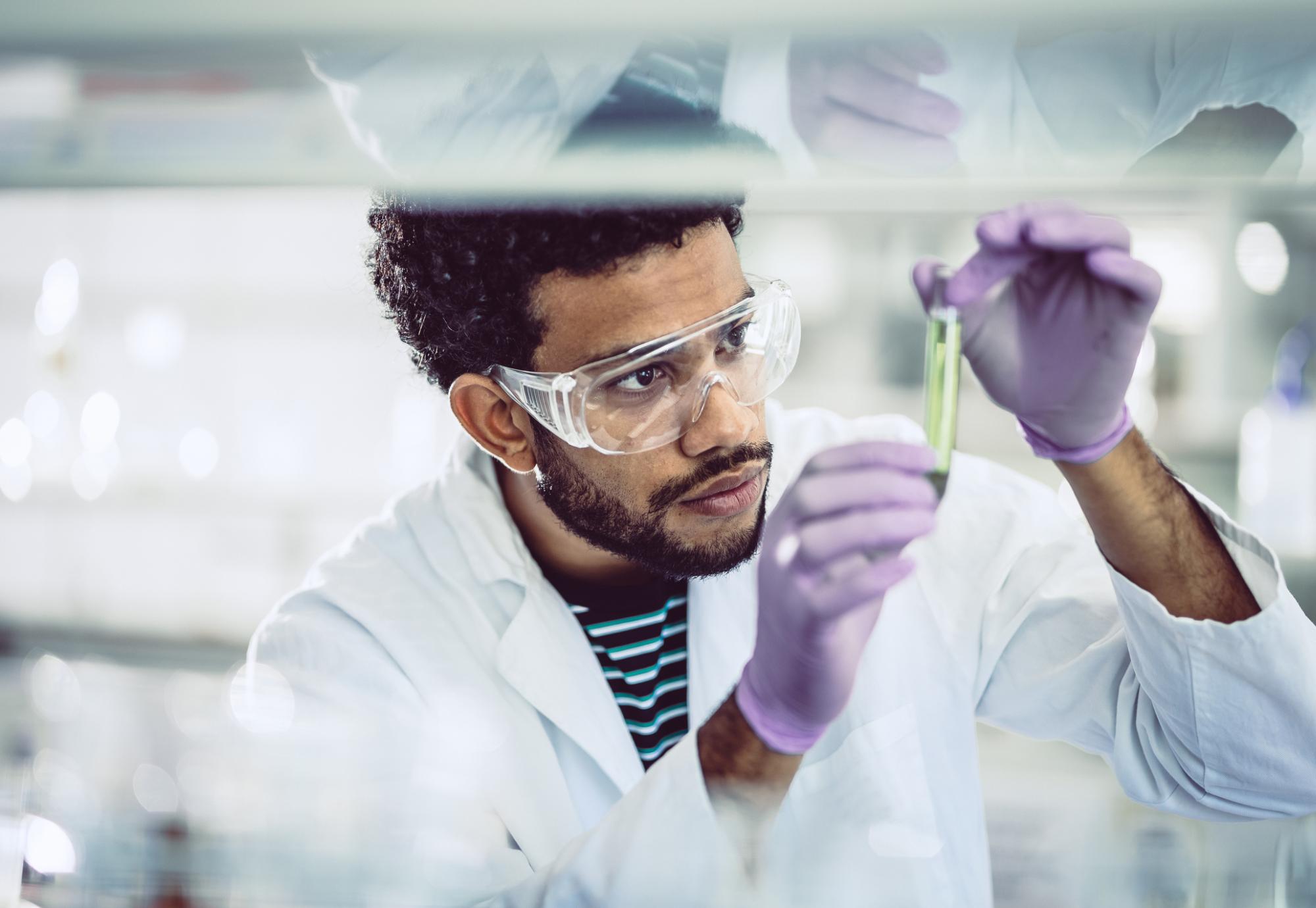 Scientist looking at a test tube in a lab