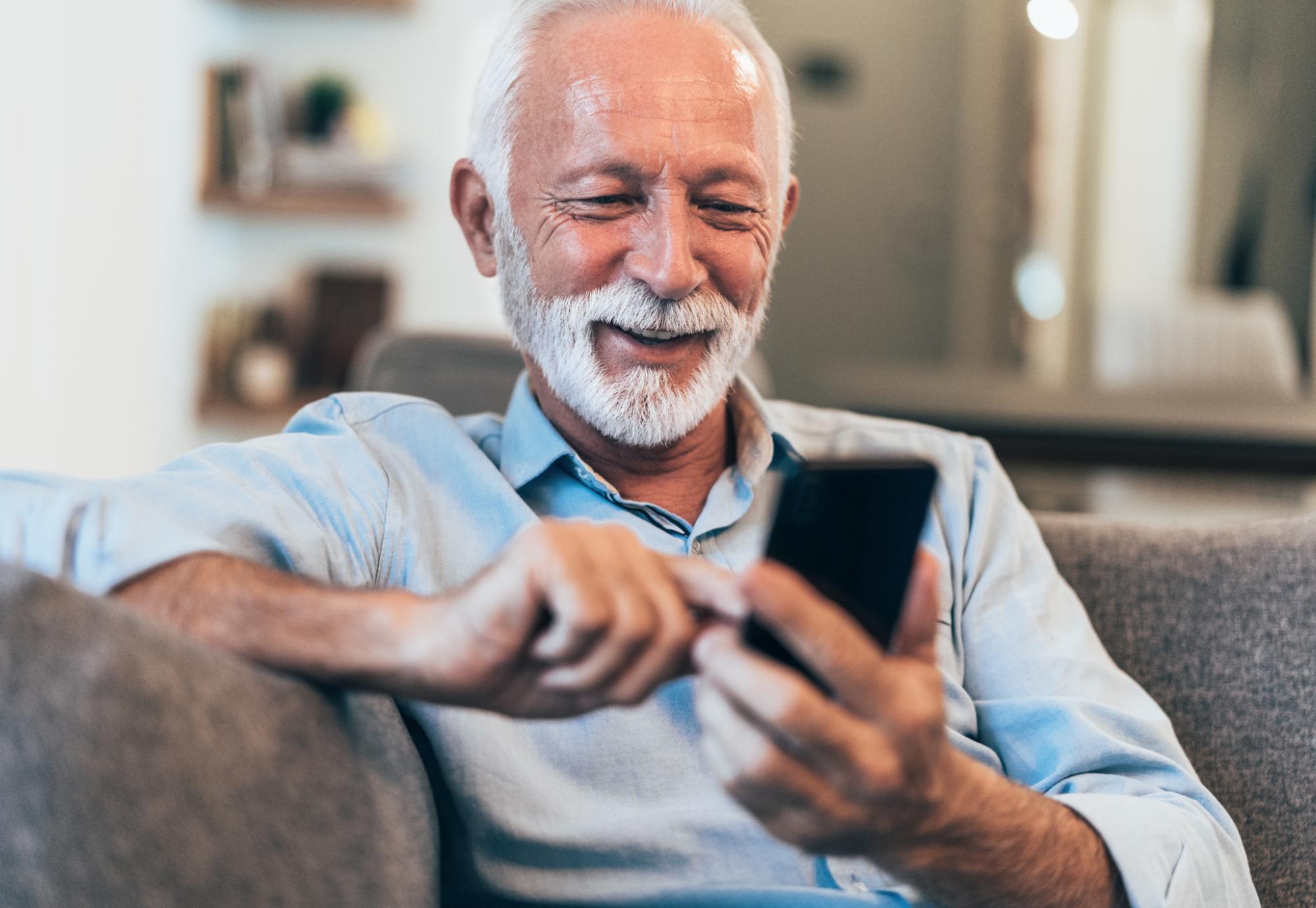 Older man using a phone to read a text message