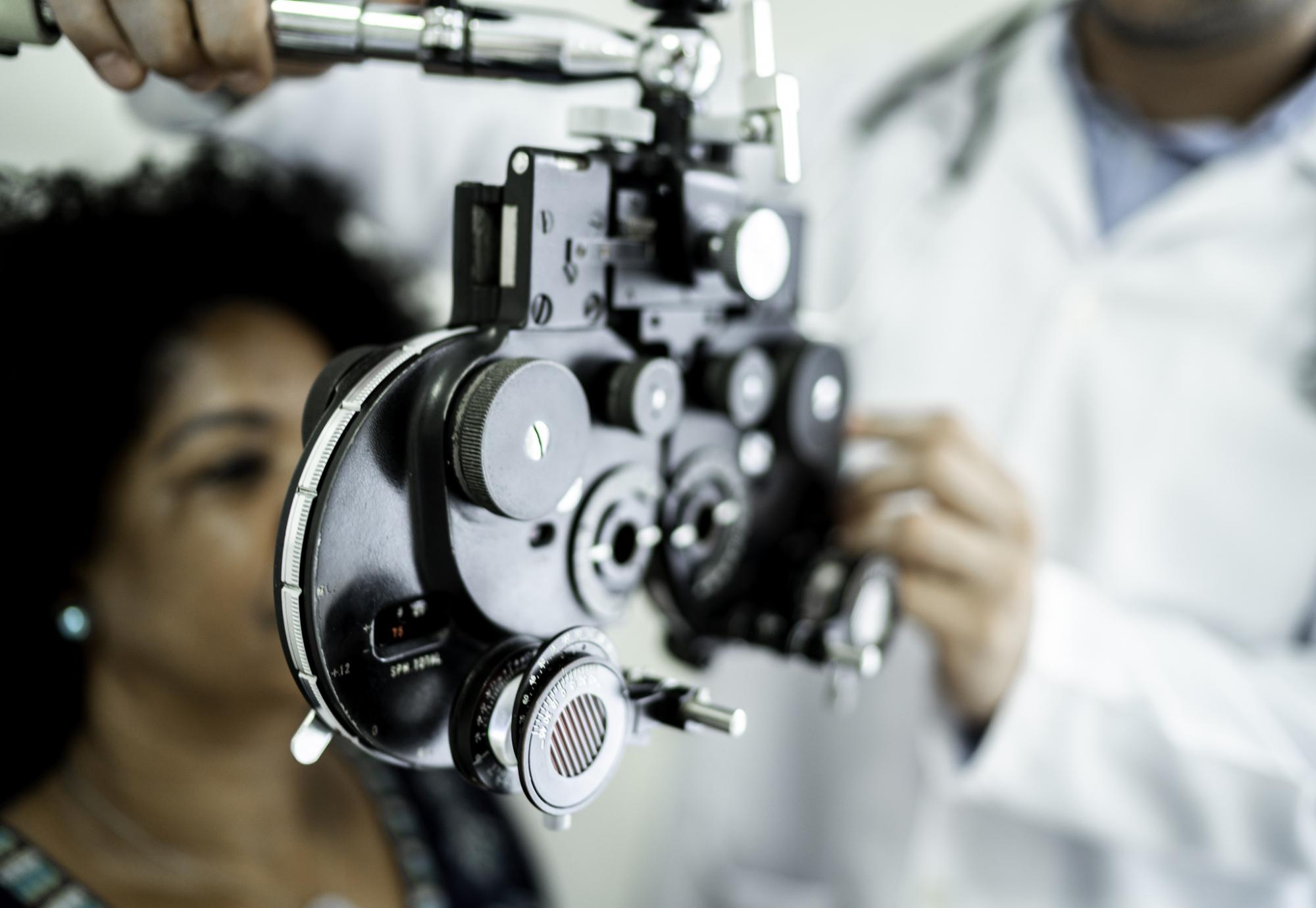 Woman being treated by an ophthalmologist using specialist equipment