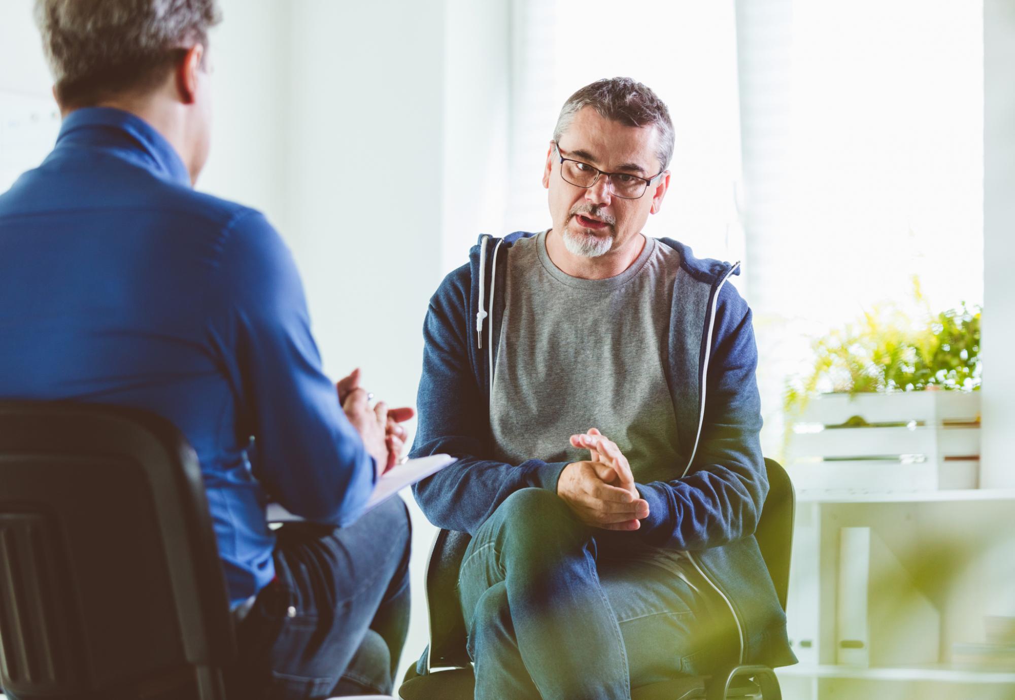 Older man talking with a mental health professional