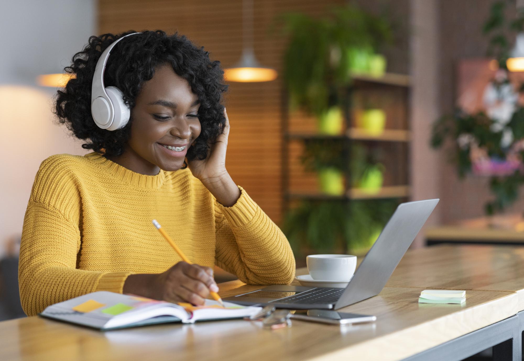 Young woman listening to online training