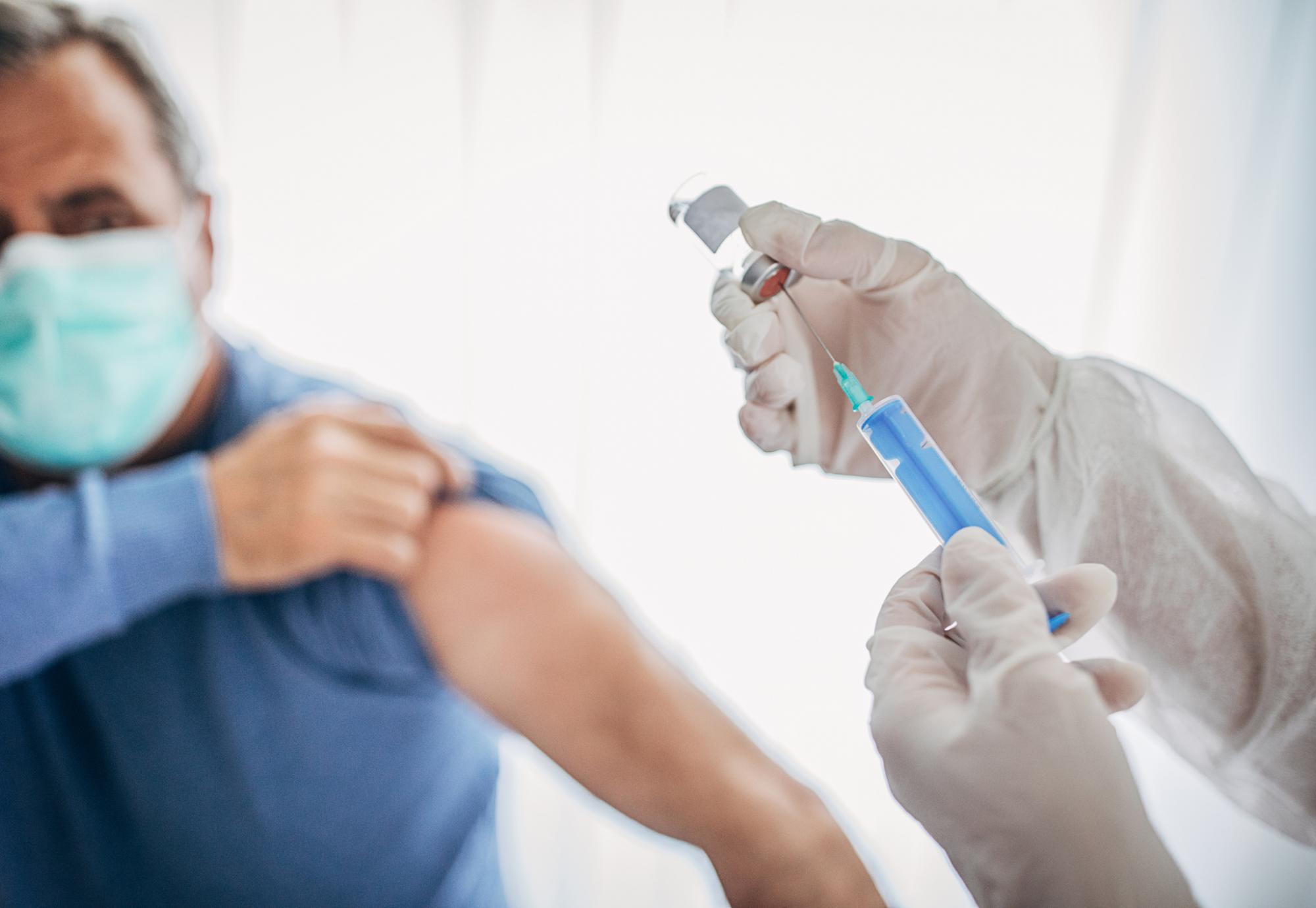 Man preparing to receive vaccine jab