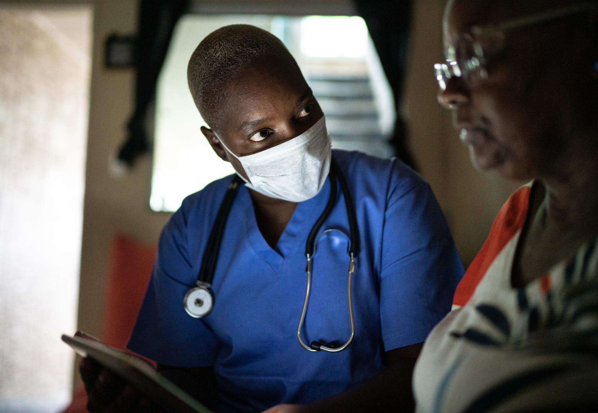 Nurse with a patient in a home visit