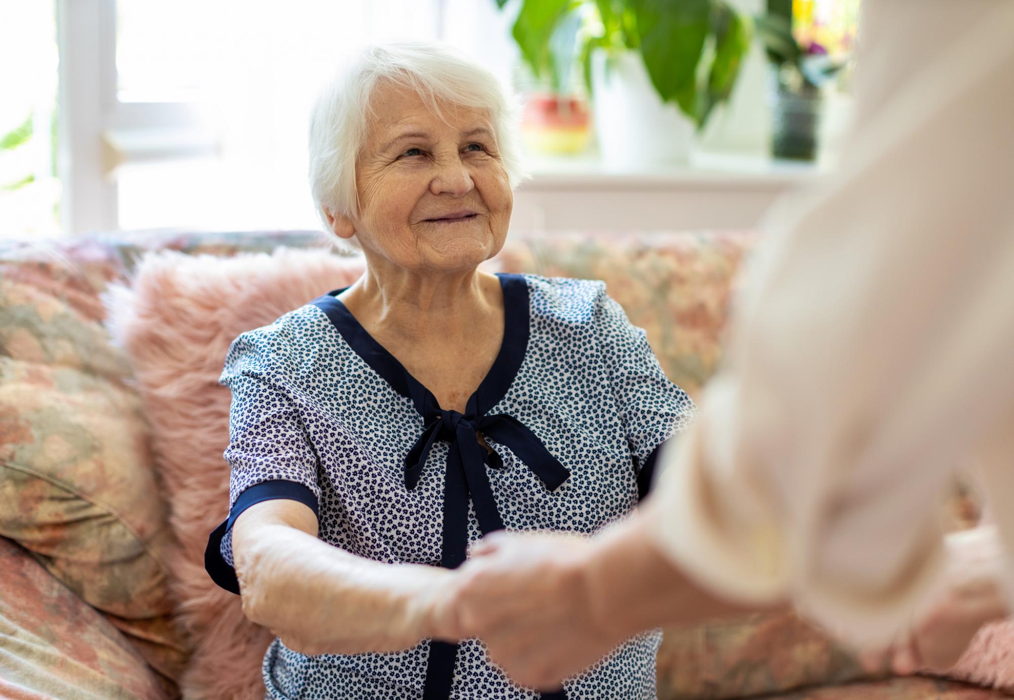 Care home resident talking with a staff member