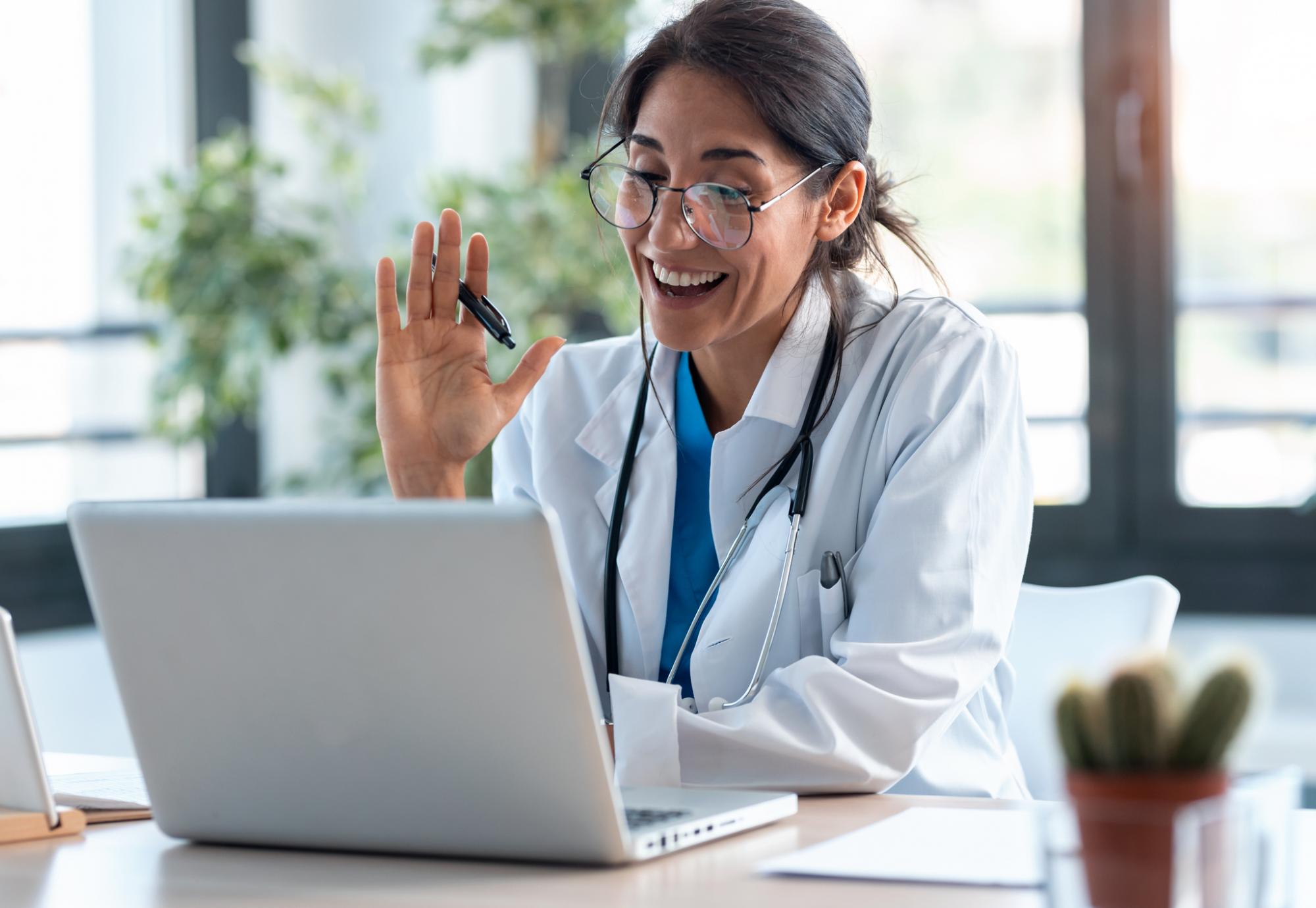 Doctor using a laptop to carry out virtual clinics