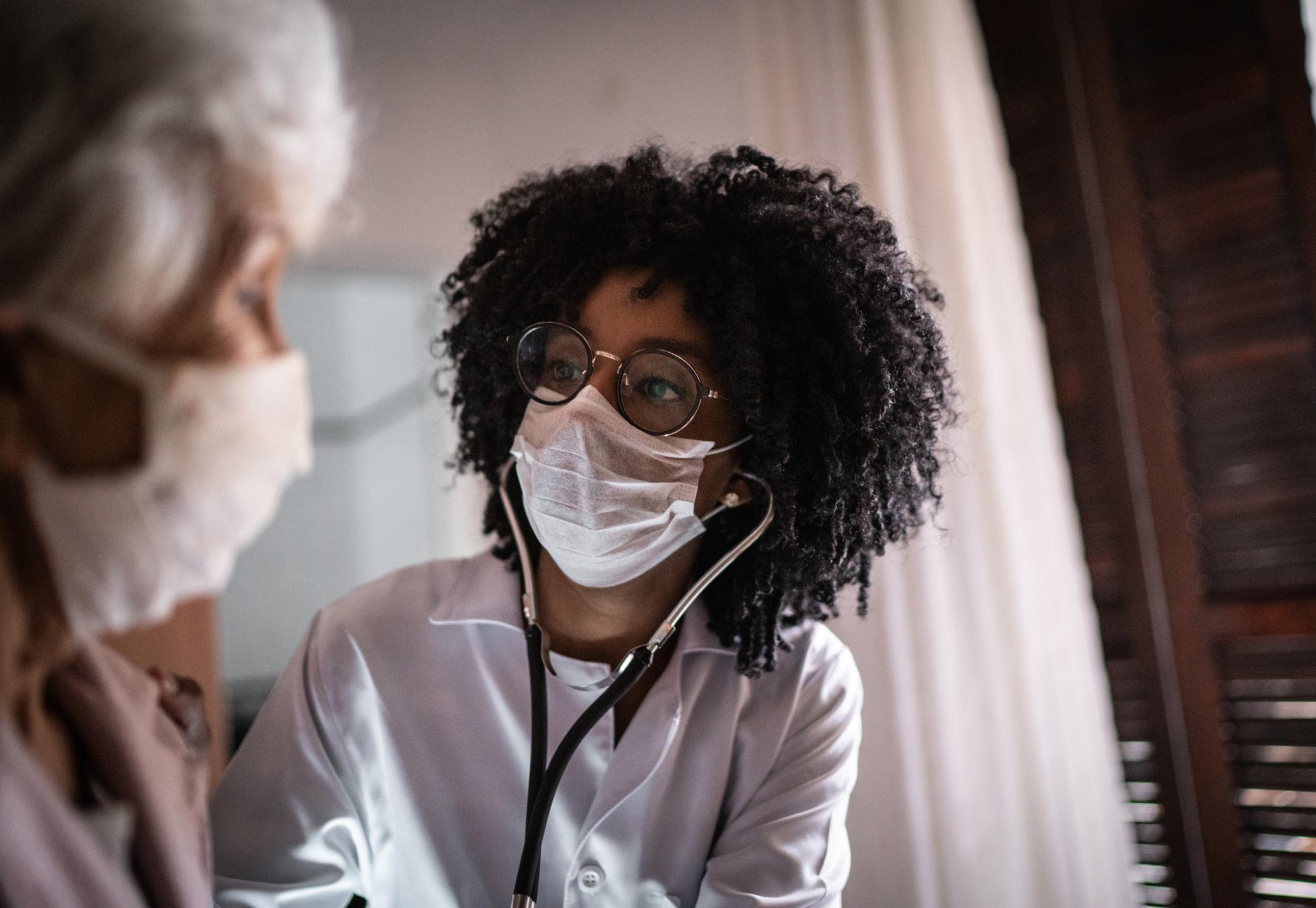 Woman providing medical care for an elderly patient