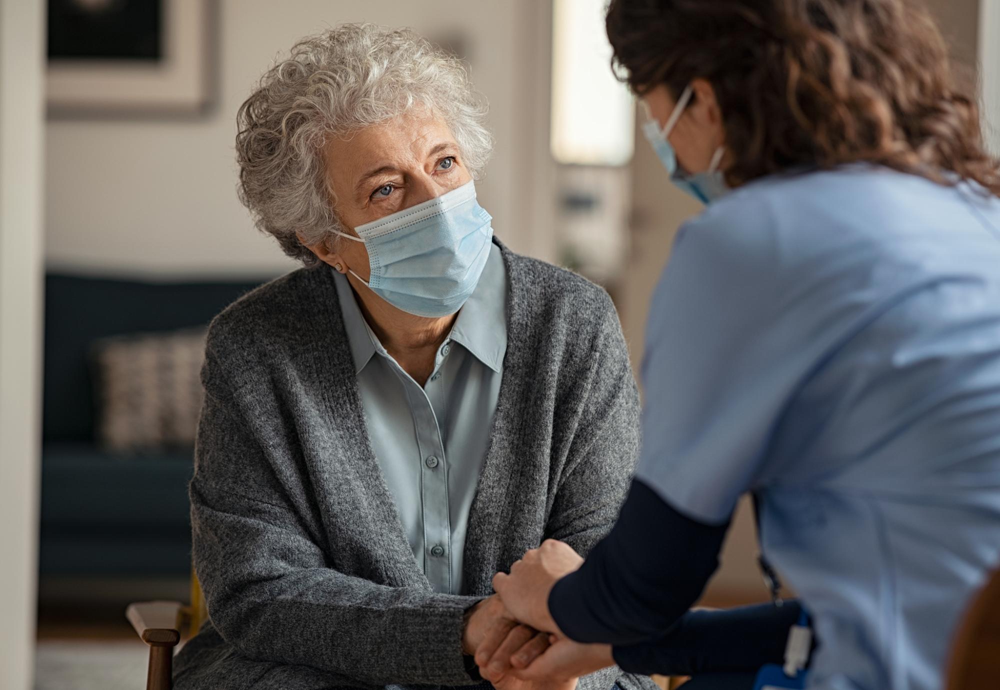 Elderly resident talking with a supportive carer