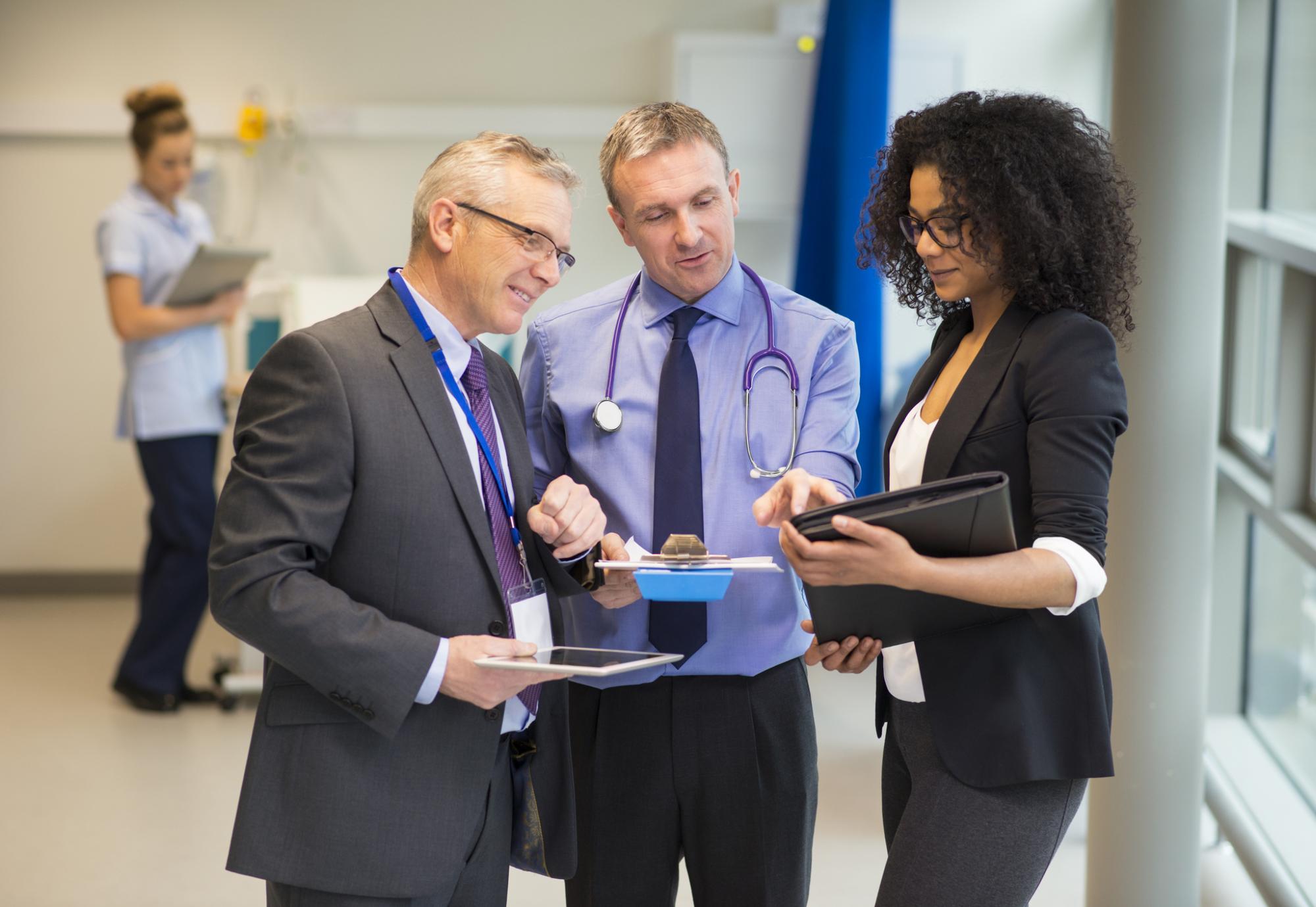 Hospital administrative team discussing a patient record