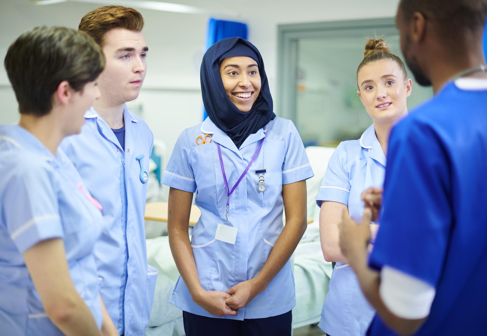 Group of young nurses learning from a colleague