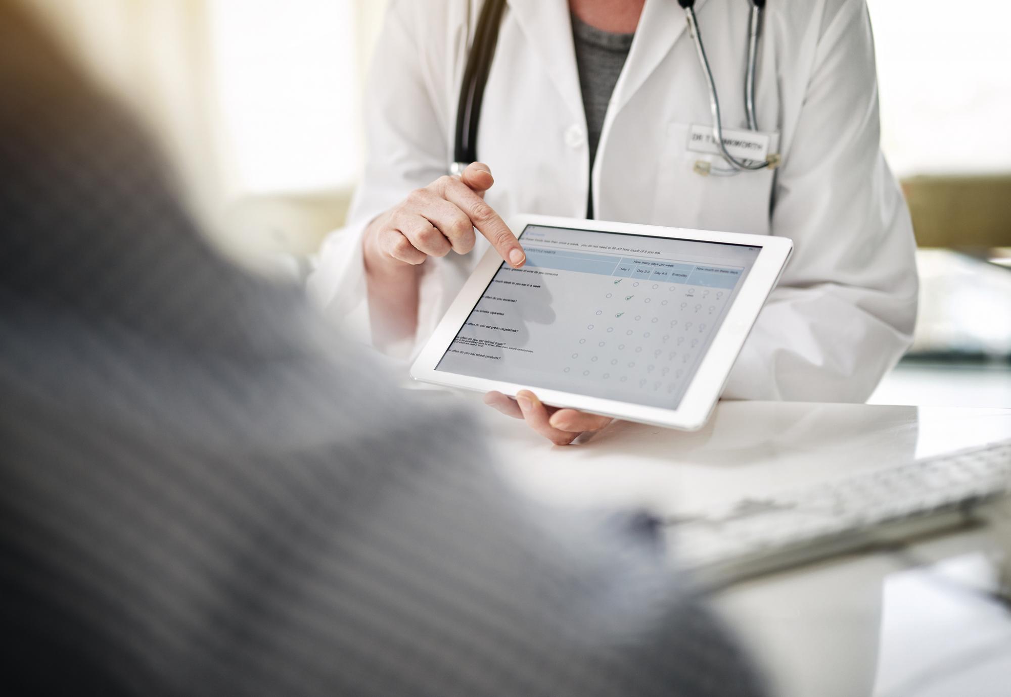 Health professional accessing a form on a tablet PC