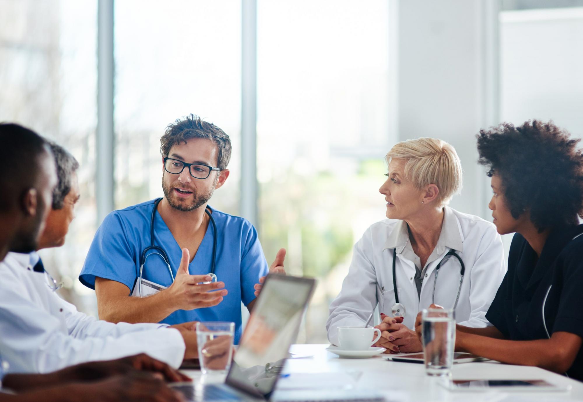 Doctors sat in a meeting discussing plans