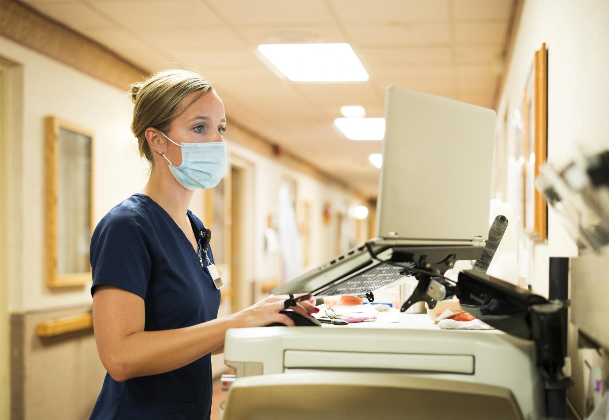 Nurse using a computer on a hospital ward