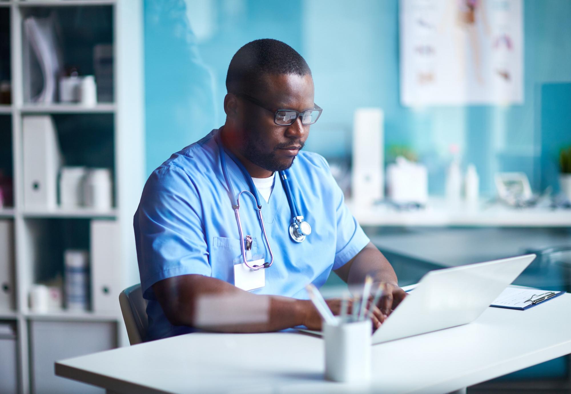 Nurse using a laptop to talk with patients