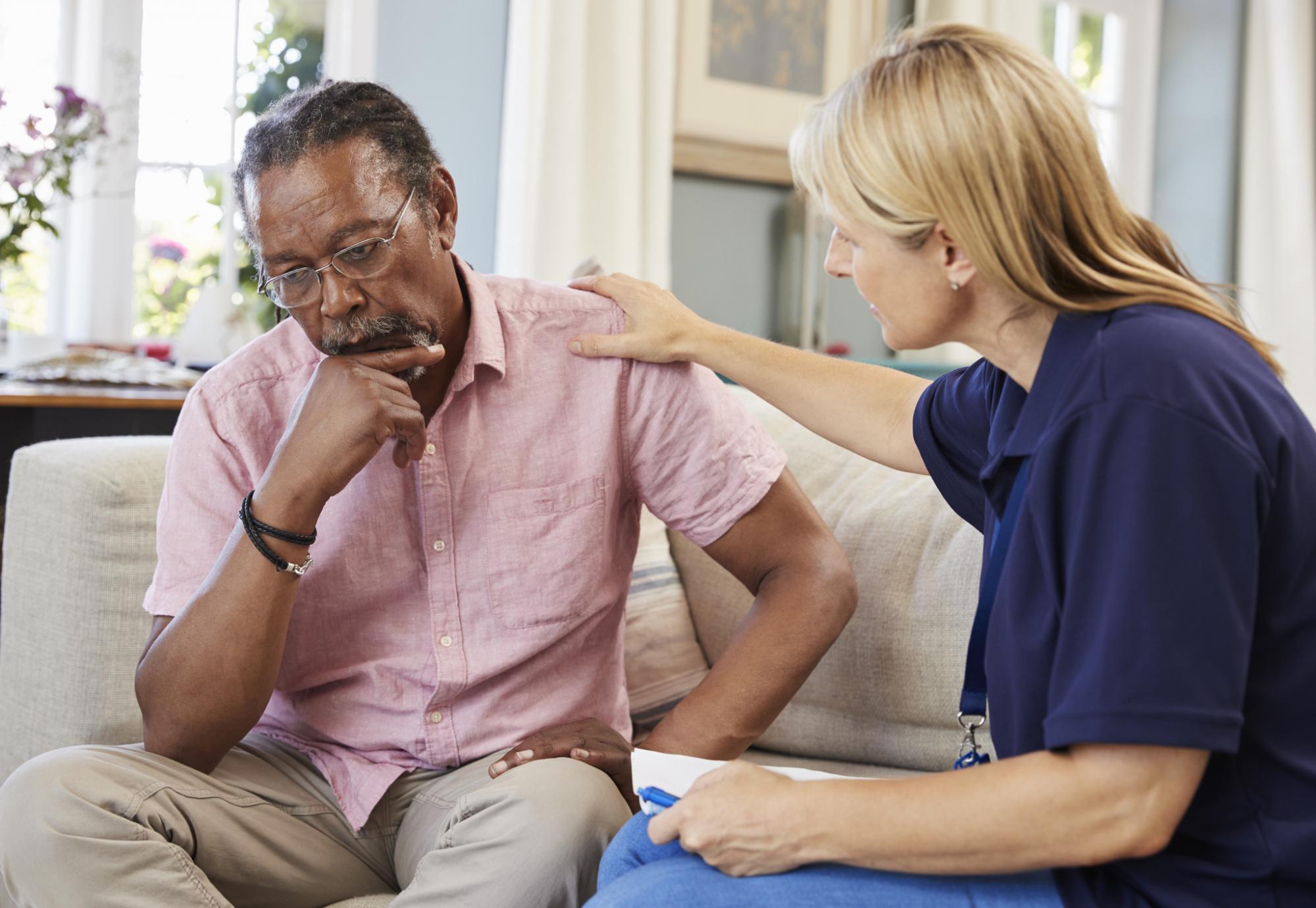 Social worker talking with an older man