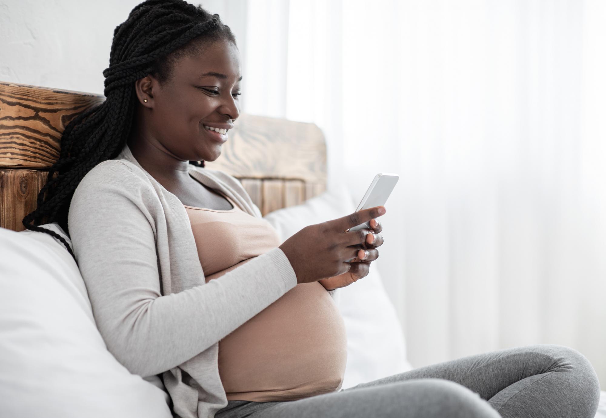 Pregnant woman using a mobile phone