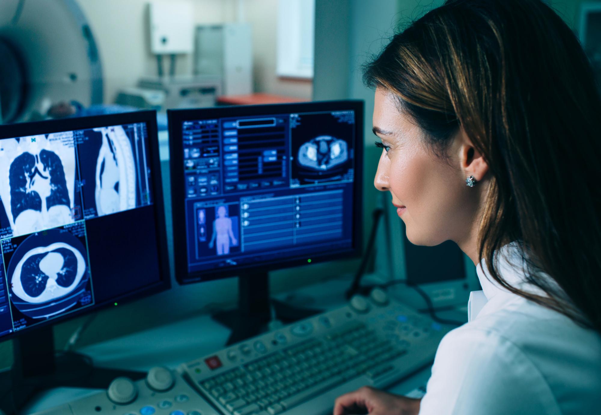 Female radiographer looking at a chest CT scan