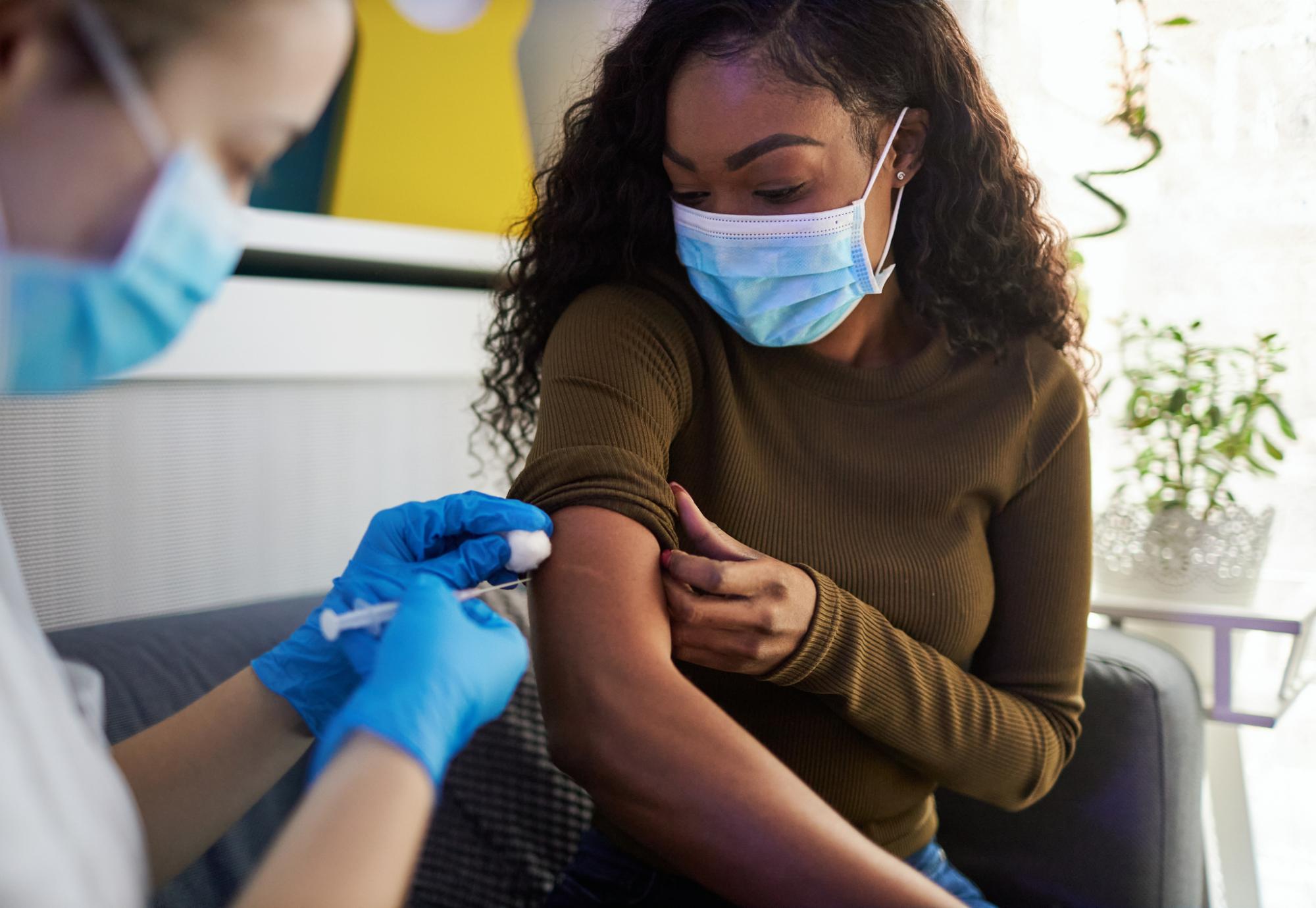 Vaccine jab being administered by a health professional
