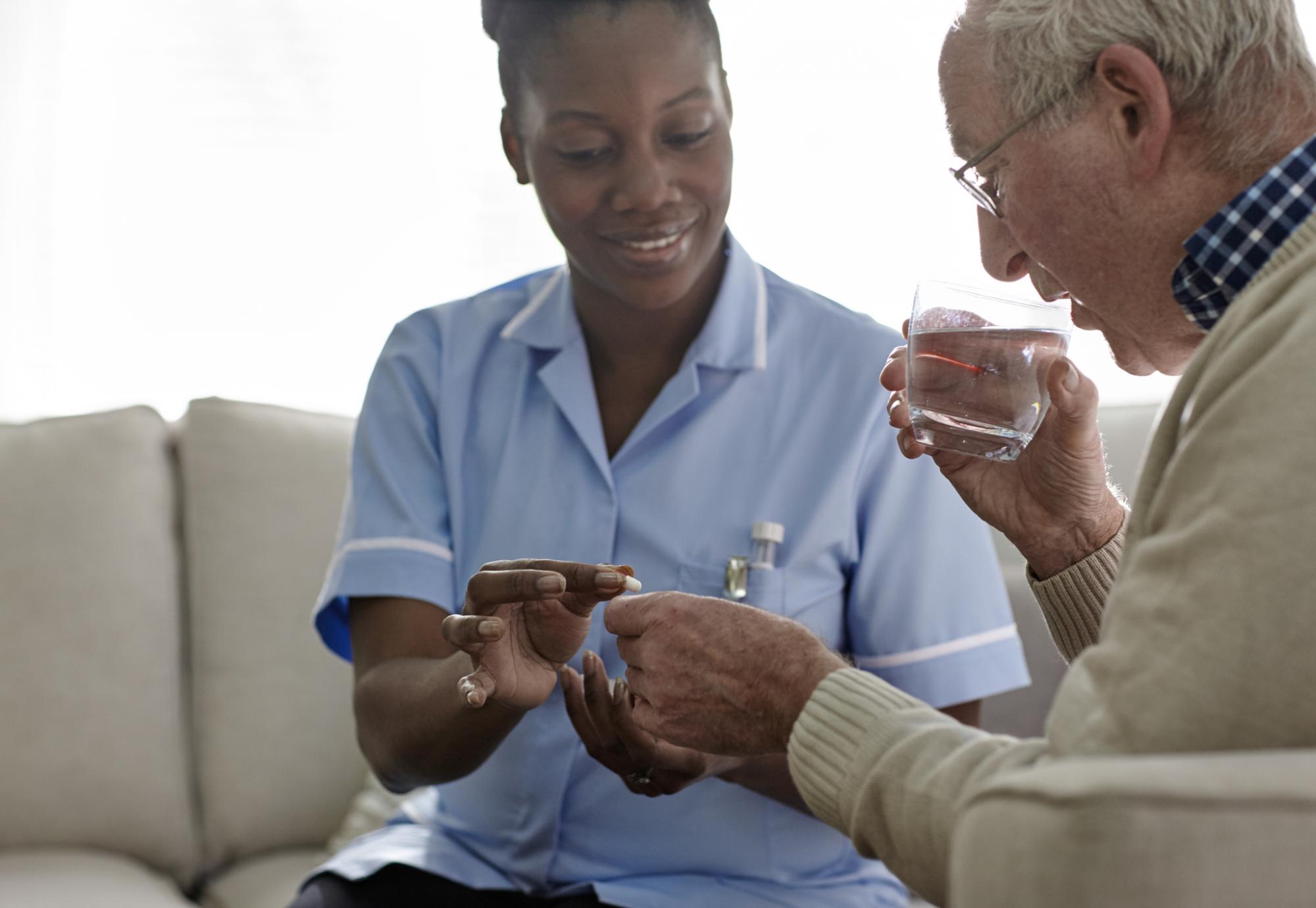 Female social worker helping an elderly resident