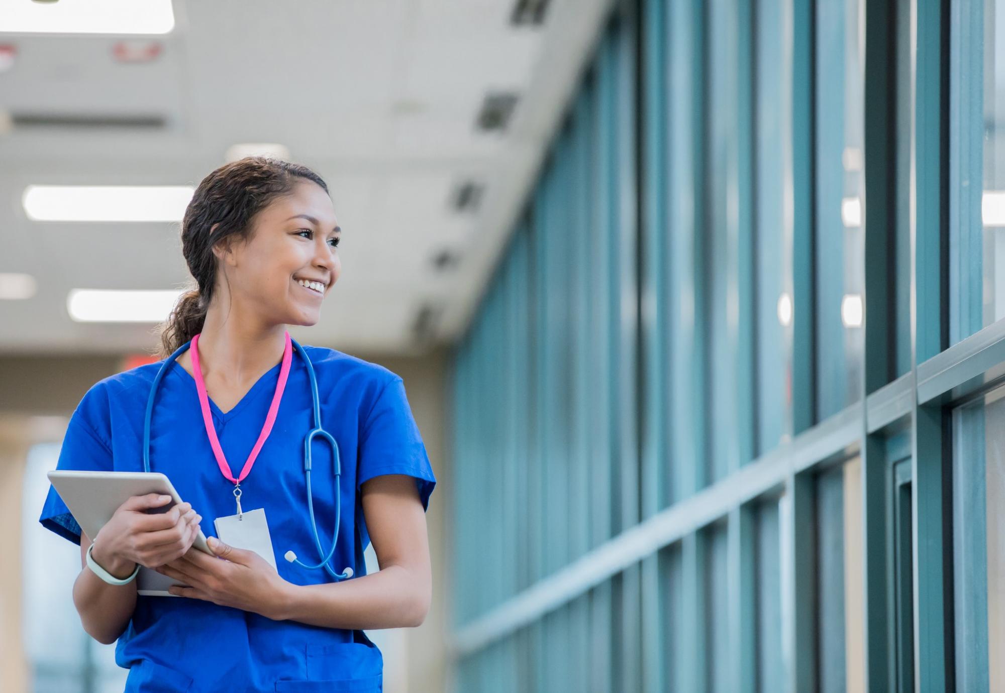 Nurse with a tablet walking in a hospital