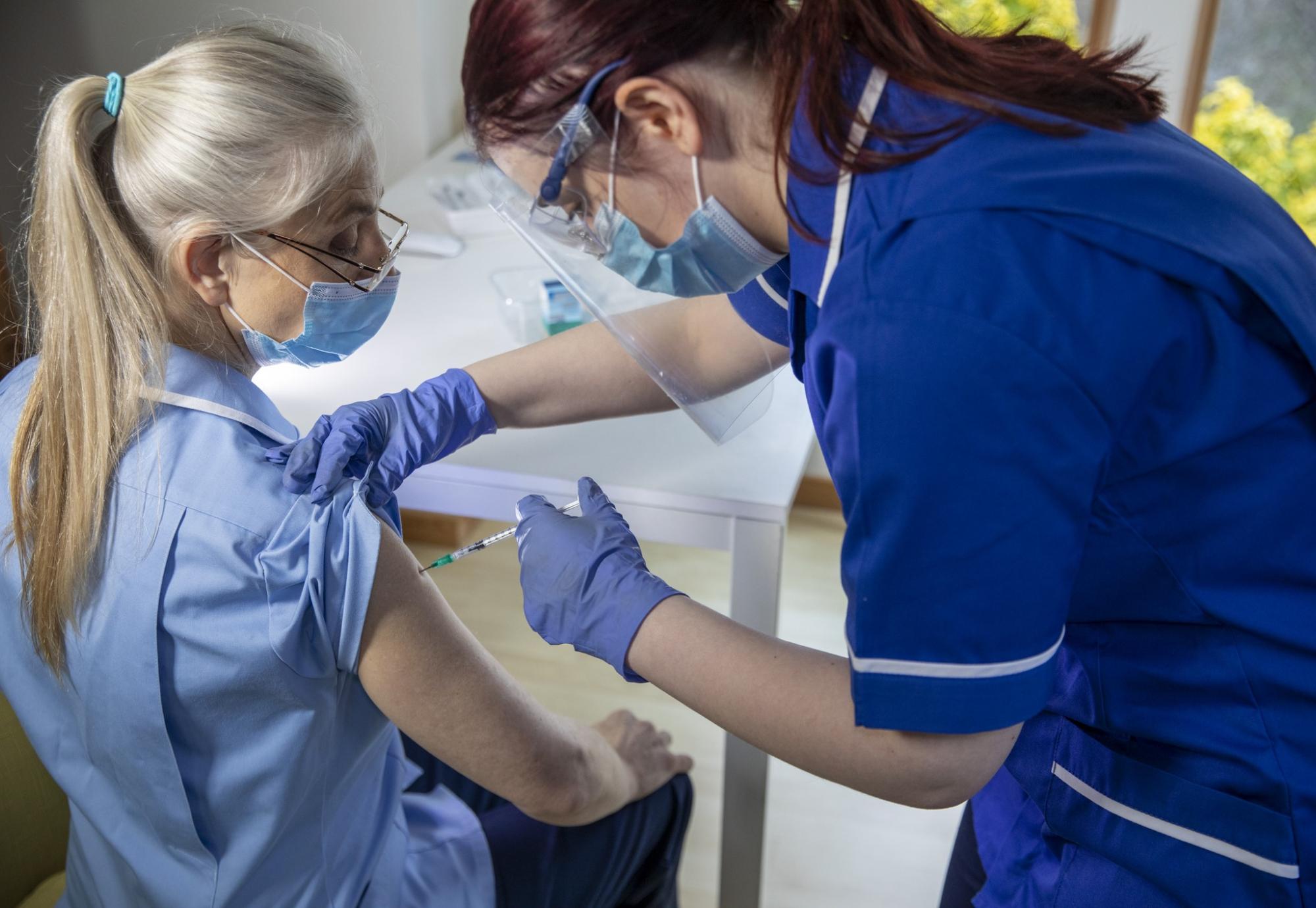 nurse receiving vaccine 