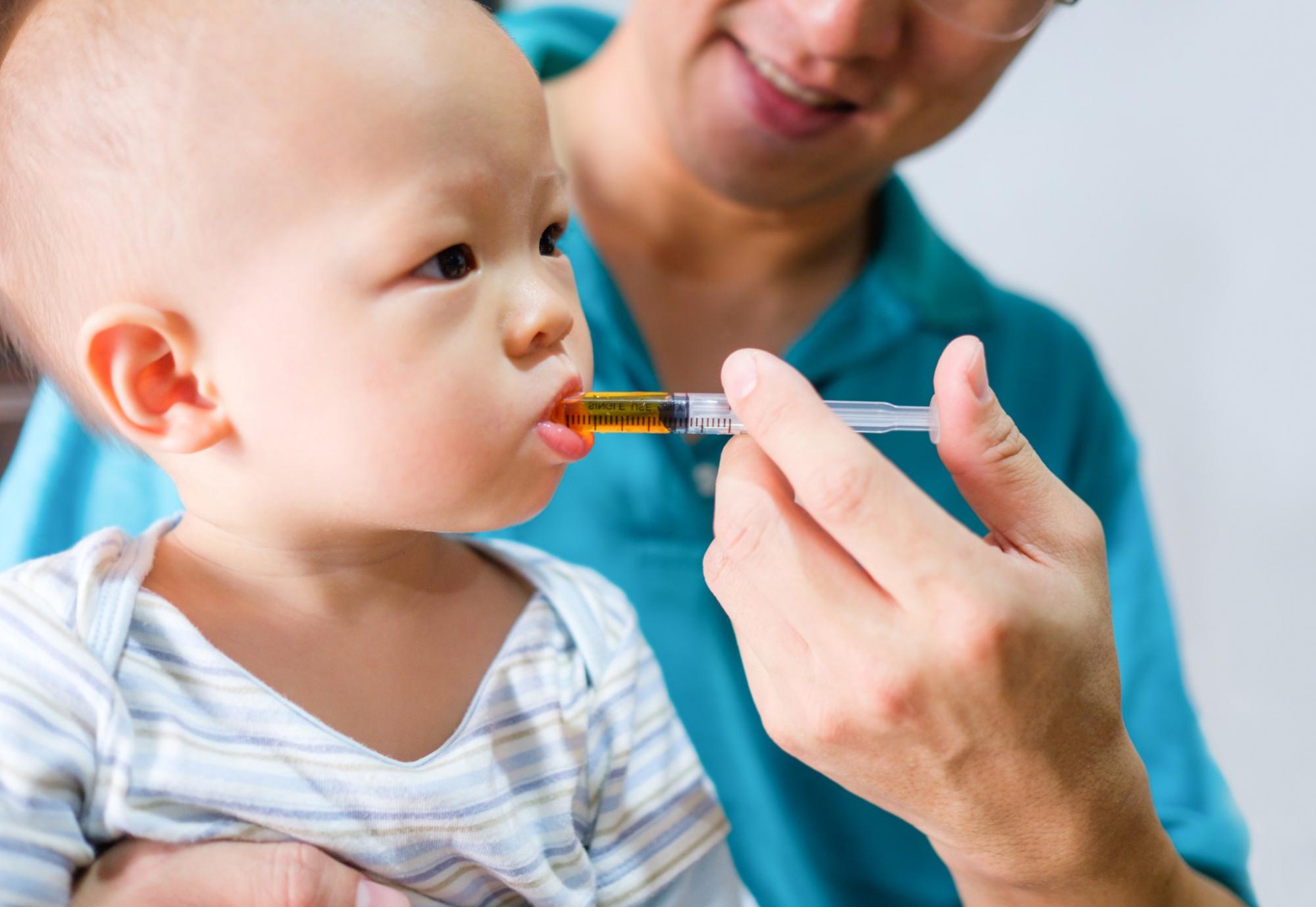 baby being given medicine 