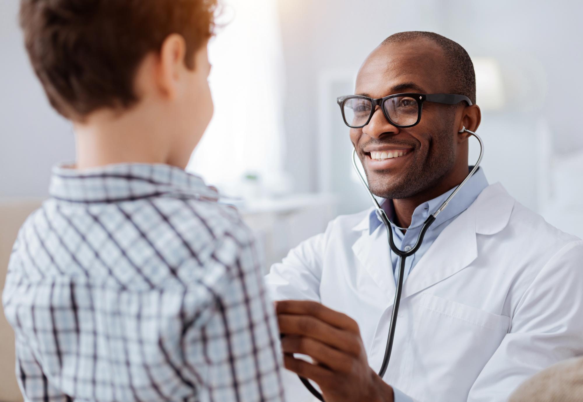 Doctor checking a child's airways with a stethoscope