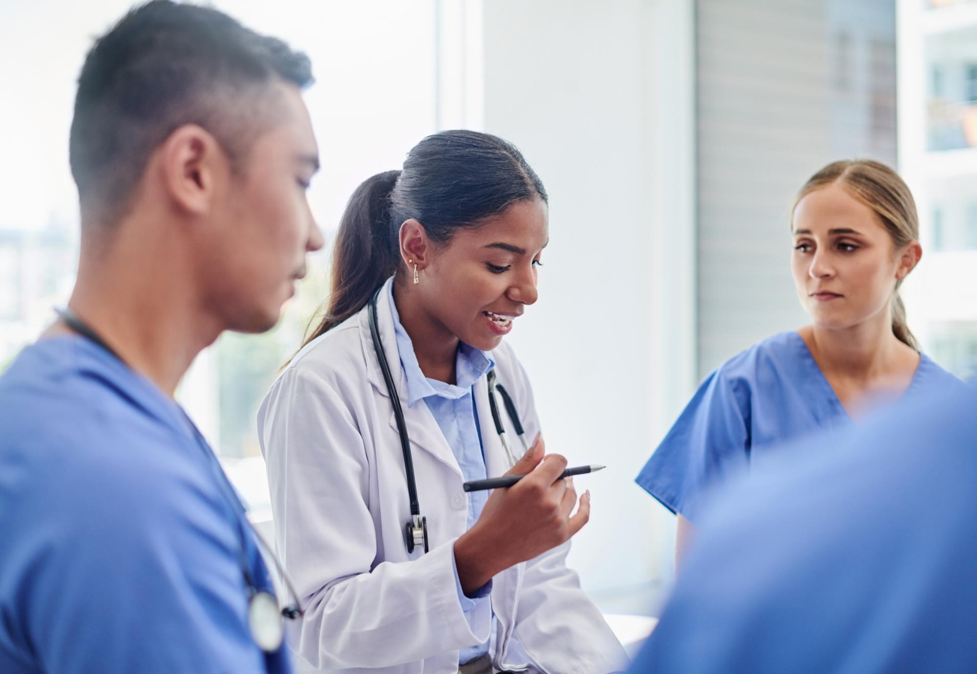 Doctors and nurses talking in a group