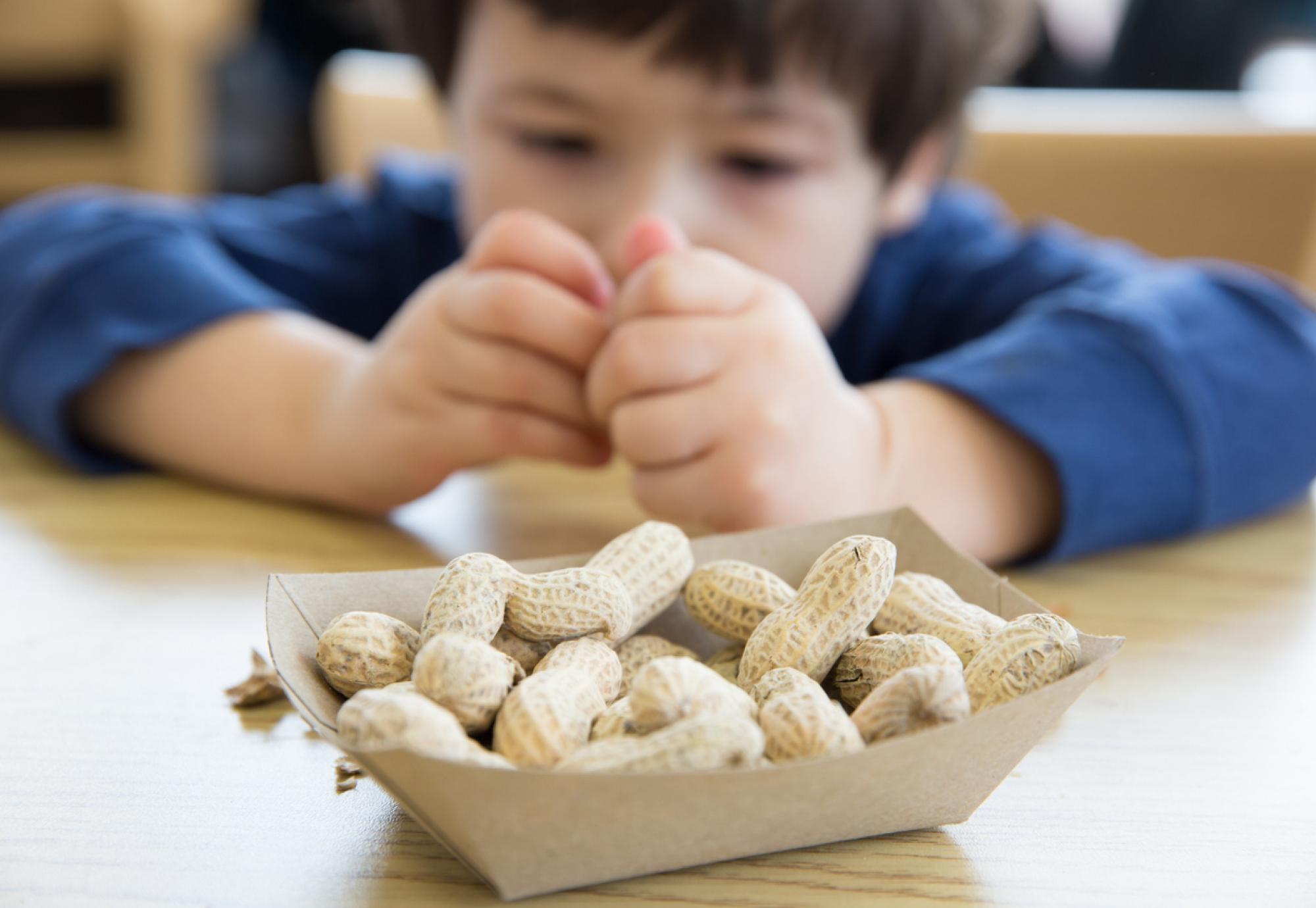 child holding peanut 