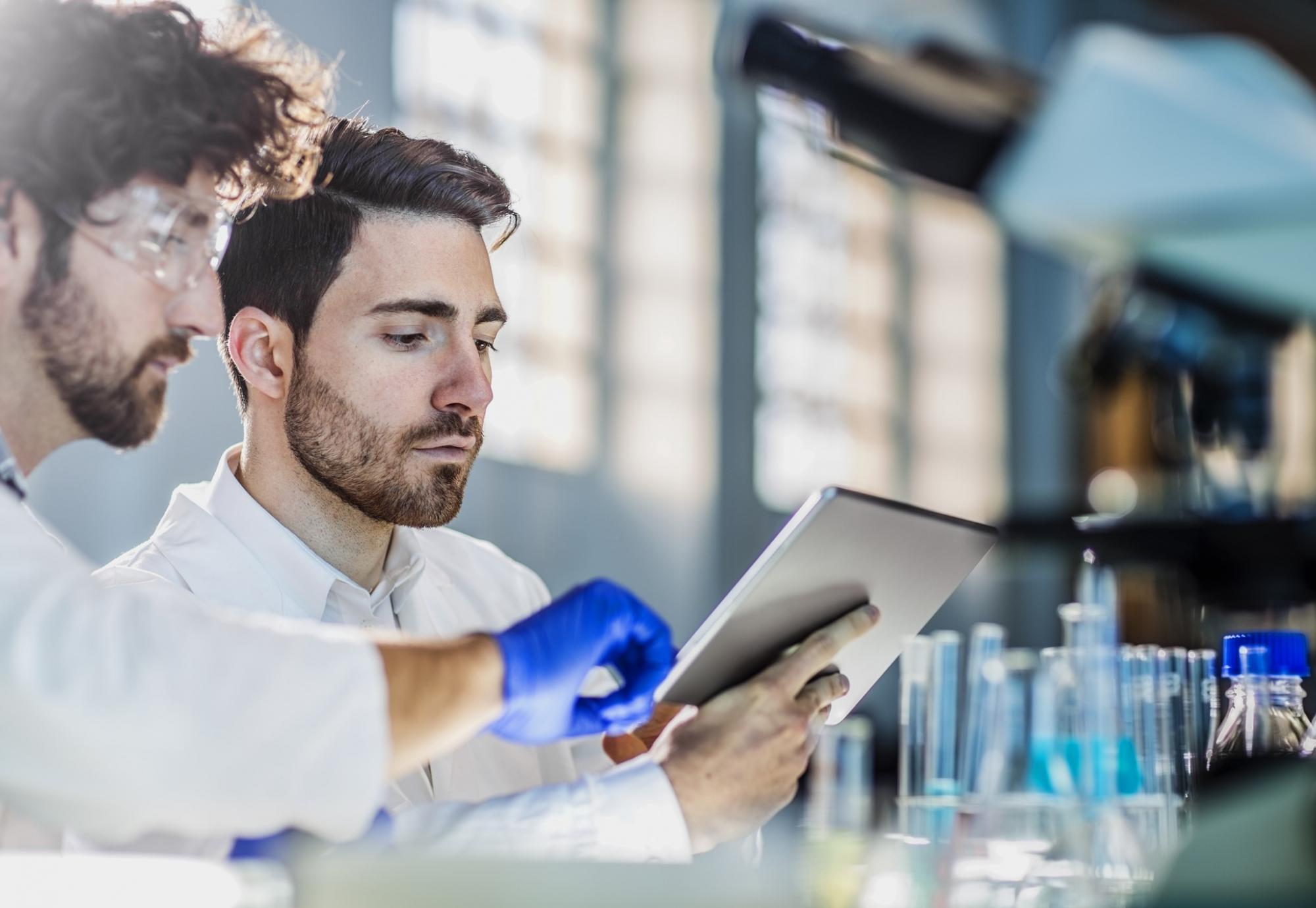 Lab workers looking at some data