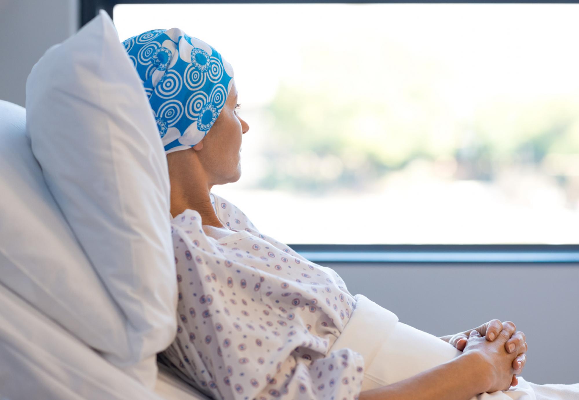 woman with cancer laying in hospital bed 